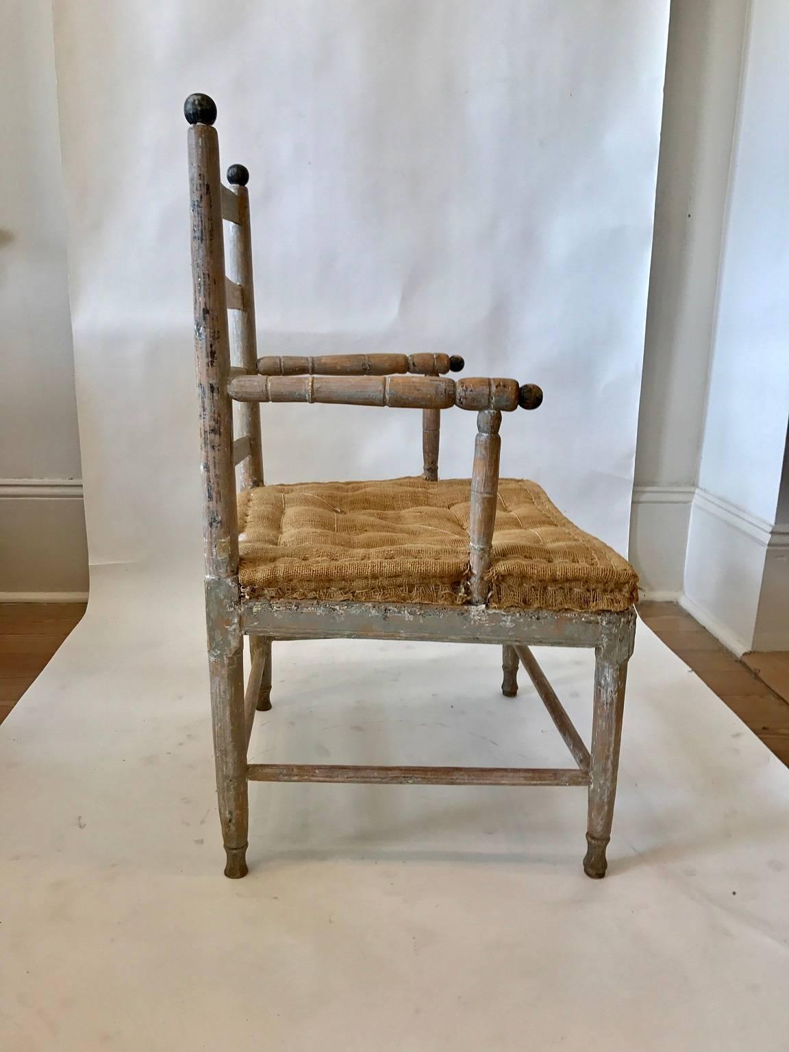 Swedish Gustavian Gripsholm armchair; the ladder-back form with simple but attractive turnings at the arms, legs and back stiles; later paint removed.

 
