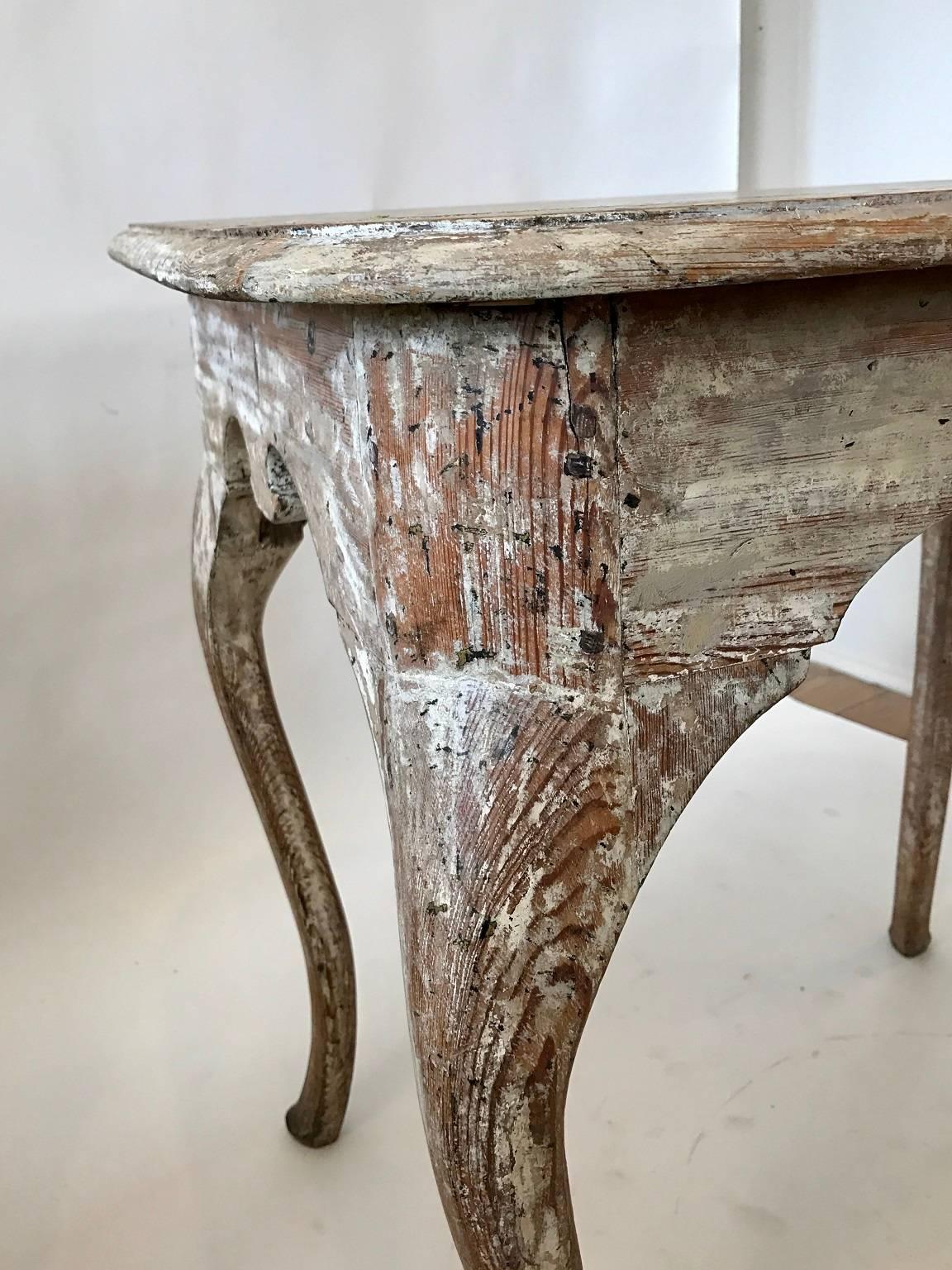 Elegantly formed 19th century Swedish Rococo tea table; shaped skirt; cabriole legs; later paint removed.
