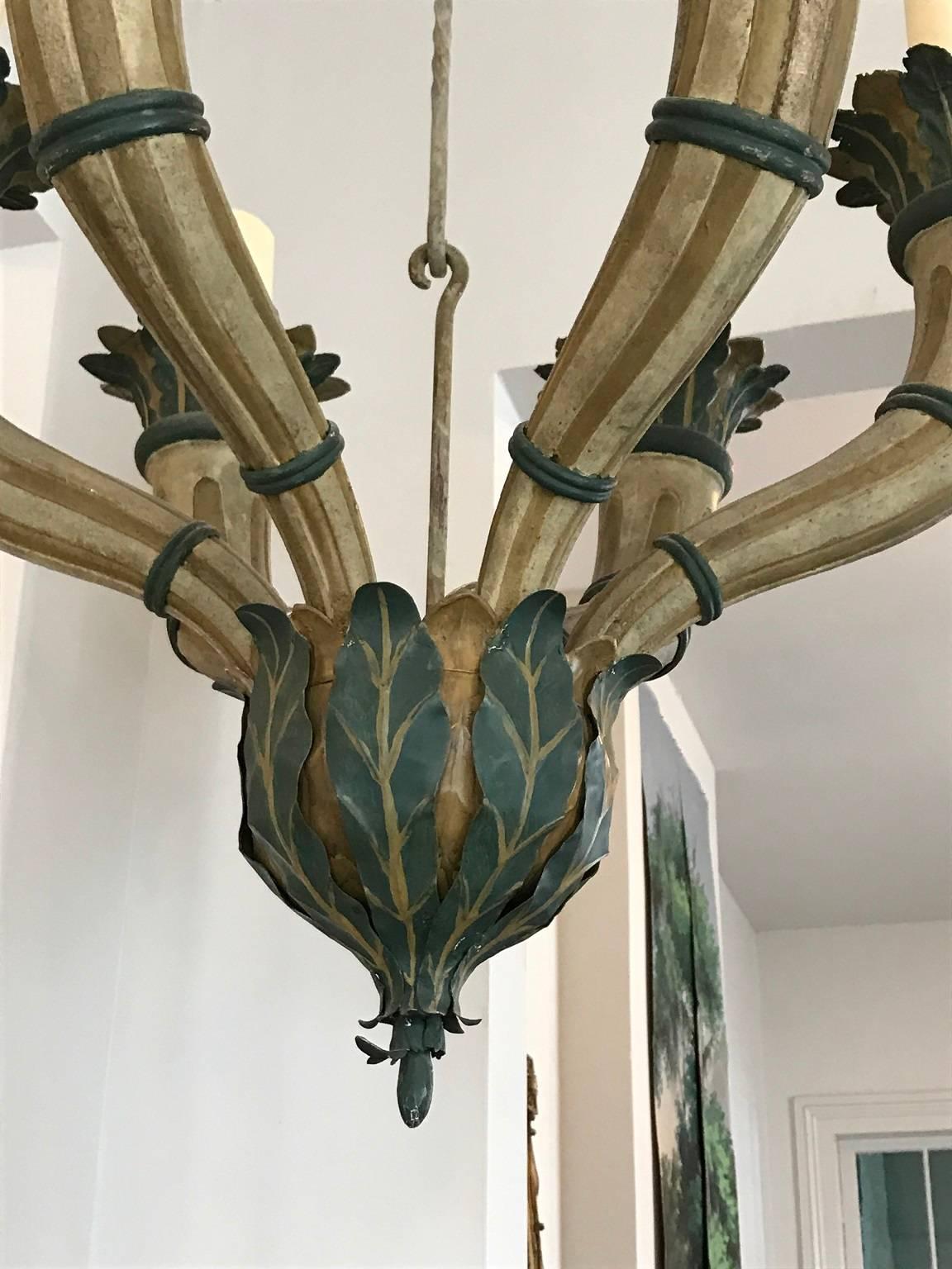 Tole chandelier of generous proportion, six horn-shaped arms supporting pillar "candles" foliate decoration throughout.