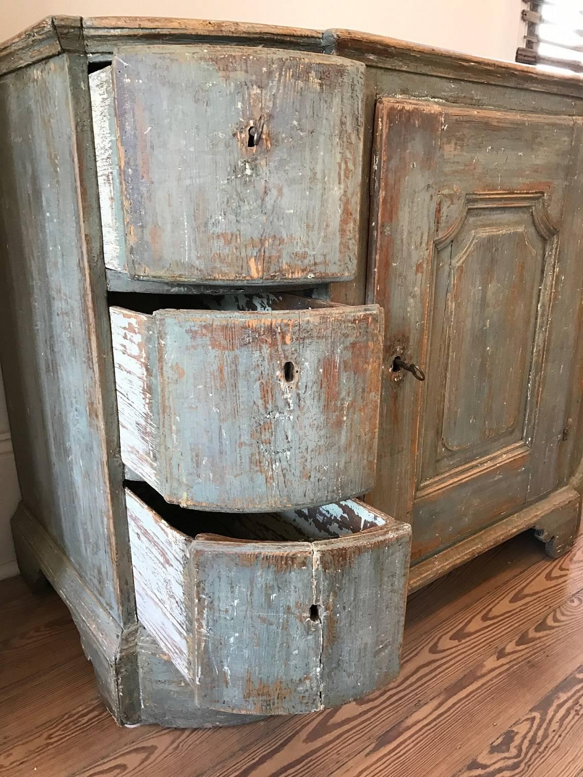 Exceptional period Swedish baroque sideboard scraped to original blue and green paint; central cupboard with three shelves flanked by drawers; wonderful patina.