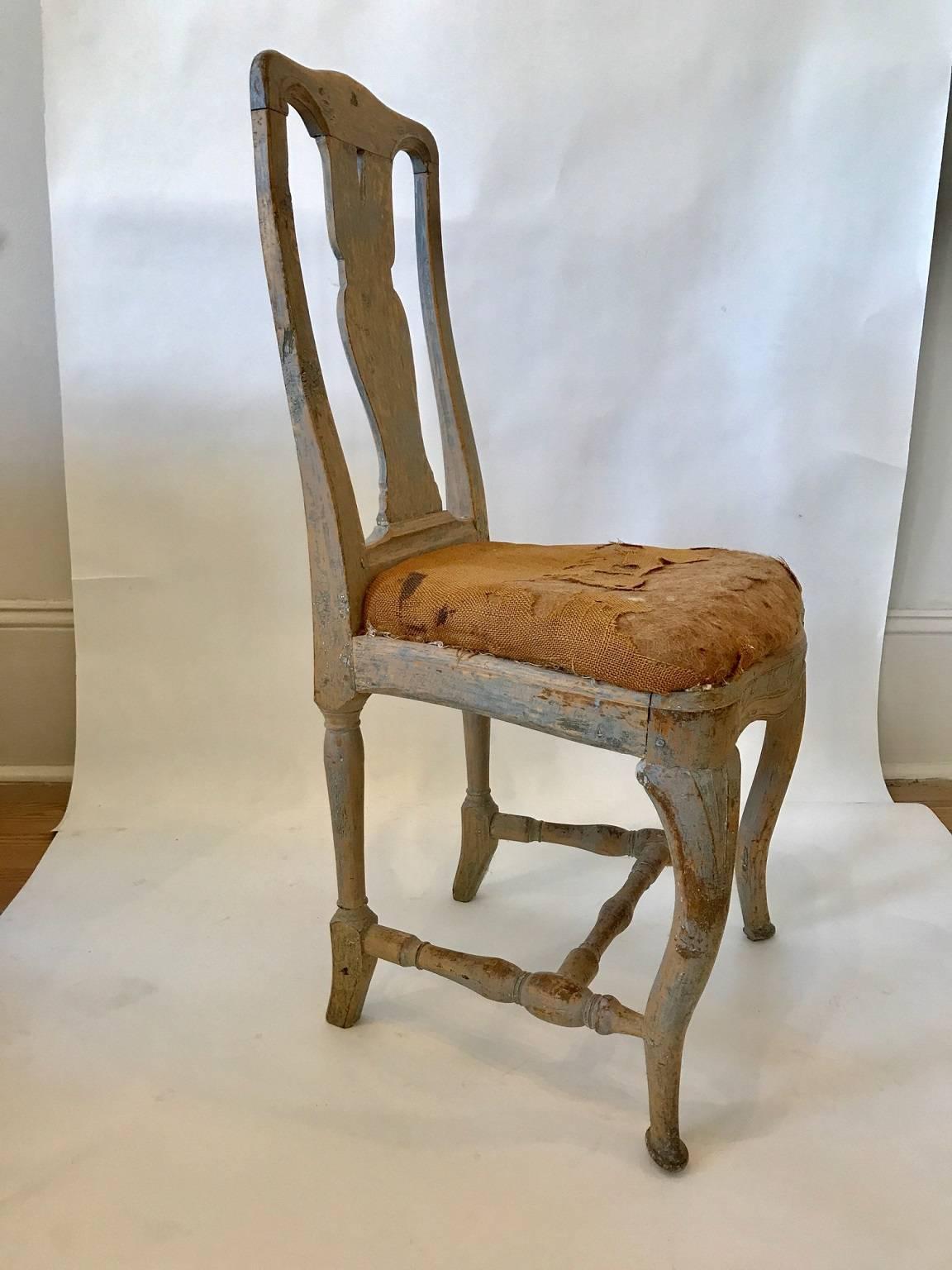 Mid-18th century. Swedish Rococo side chair retaining original paint; attractively carved throughout; gracefully shaped vasiform splat; the cabriole front legs and skirt accented with carving; turned H-shaped stretcher.