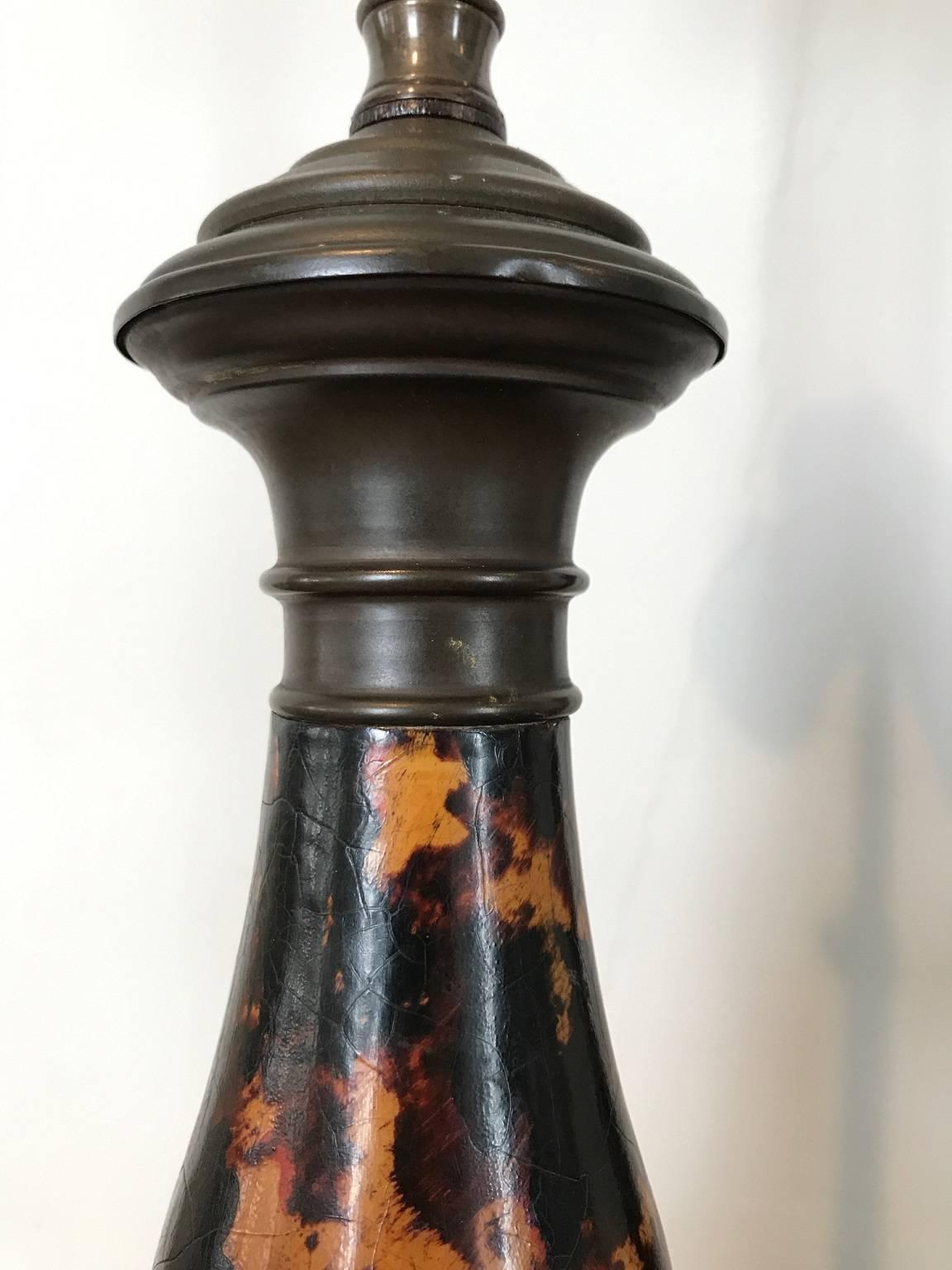 Pair of two-light table lamps with handsome faux-tortoise finish; baluster form body raised on an octagonal base; decorative details in bronzed metal; turn switch in the base.
 