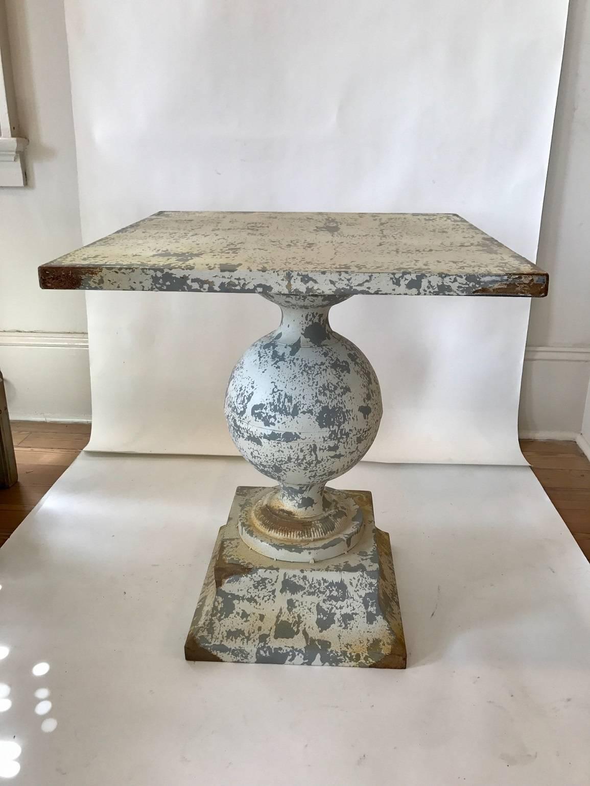 Zinc garden table with bulbous pedestal on square plinth; worn white paint.