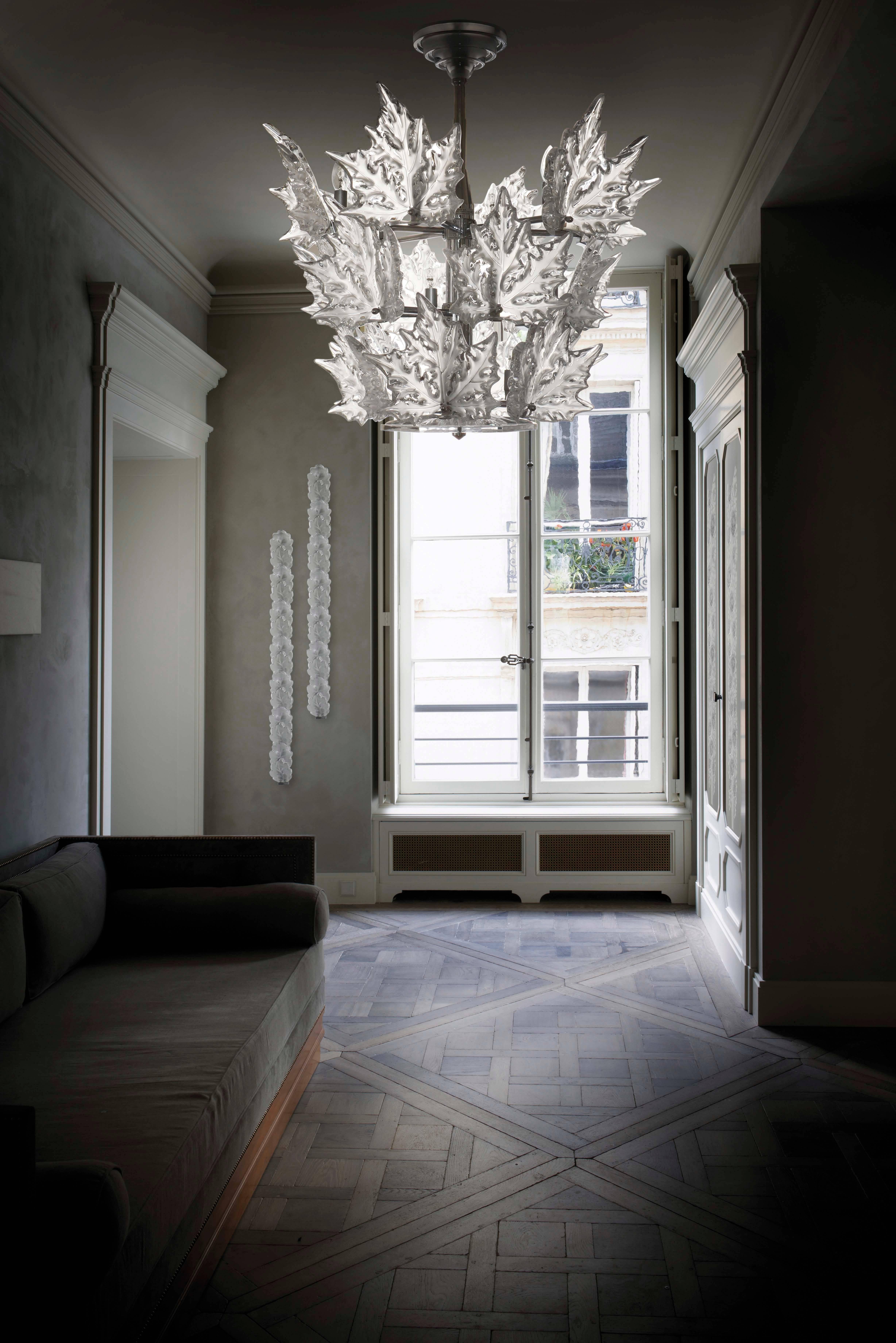 Created by Marc Lalique in 1955, the Chêne Light Ramp harmoniously complements the collection of Lalique crystal chandeliers. It consists of two crown patterns of oak leaves in satin crystal repolished on the ridges. This wall sconce is part of the