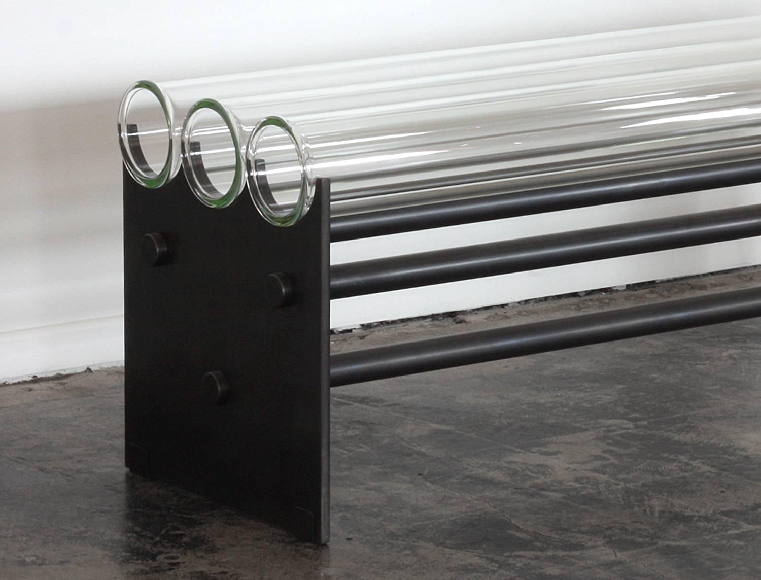 The Museum Bench was originally envisioned to be placed near art, as to not obstruct the view. 
This heavy industrial minimal modern piece is definitely a conversation starter. 
It's made of commercial grade glass pipes strong enough to hold up to