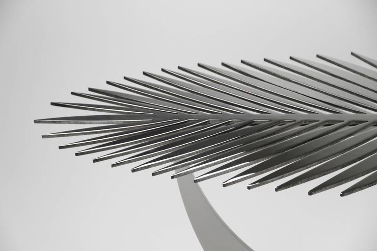 The Double Frond Table is as much a sculpture as it is a table.  This is one of those pieces that are far more interesting in person than in a photograph.  When lit from above the table creates beautiful shadows on the floor and reflects the