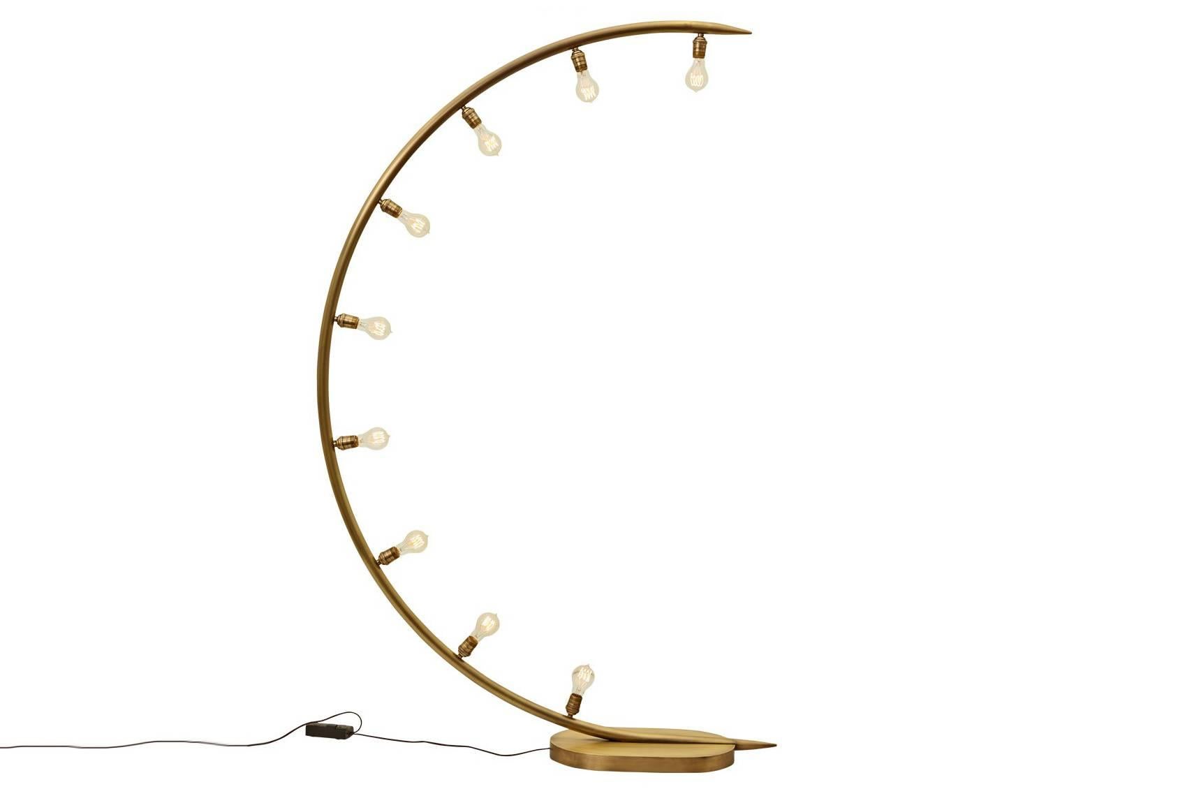 The crescent moon floor lamp is made of hand forged bronze and has nine medium bulb sockets. The bulb choice dramatically changes the look and vibe of the lamp as well as its effect on the room. Nine Edison style bulbs are included. The Crescent