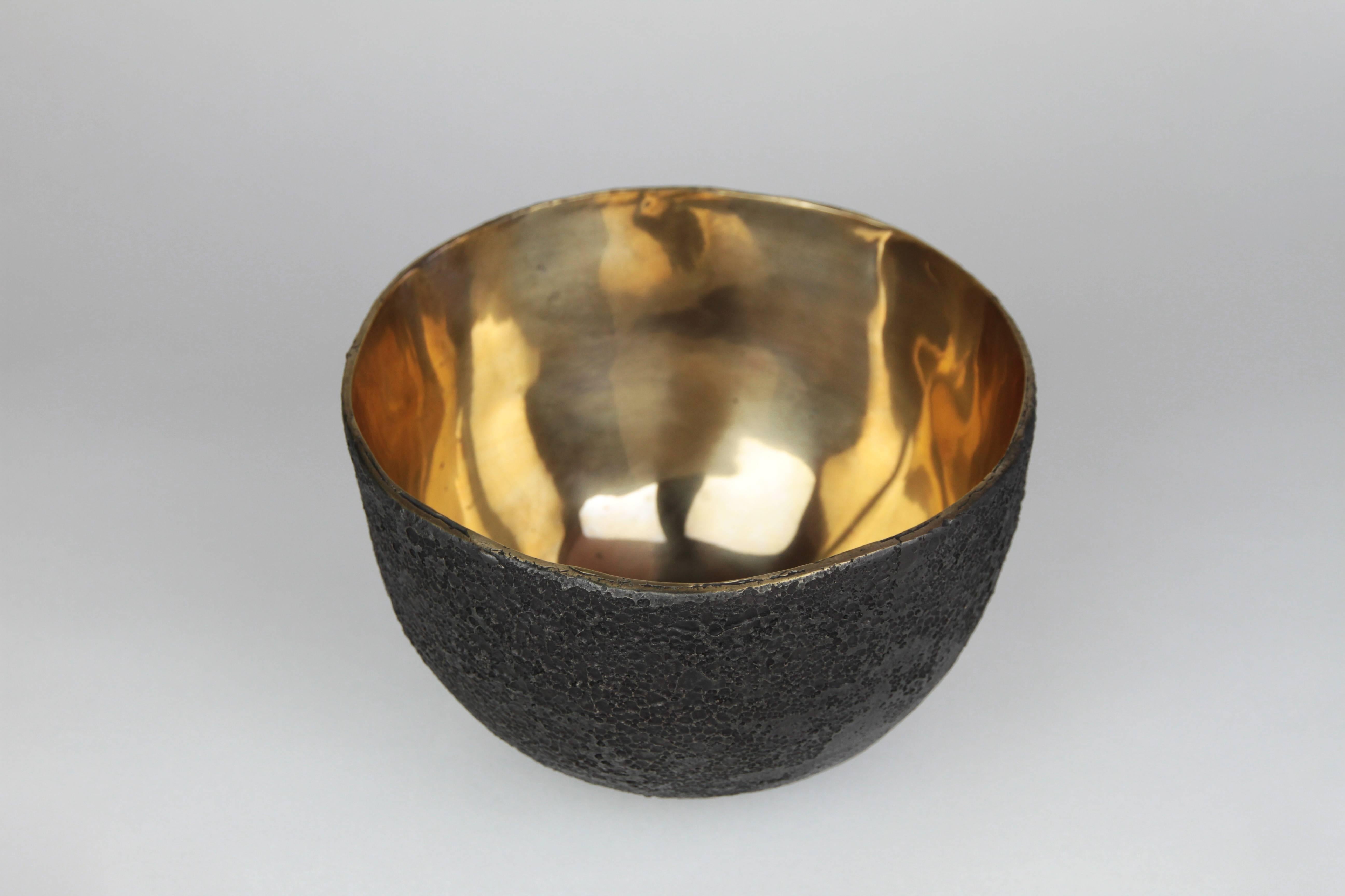 The crater bowl is the theoretical shape a Meteorite may have formed when crashing into lava rock. The hand-carved original was cast in bronze and patinated on the outside with a high polished exterior. The outside of the heavy bowl has the texture