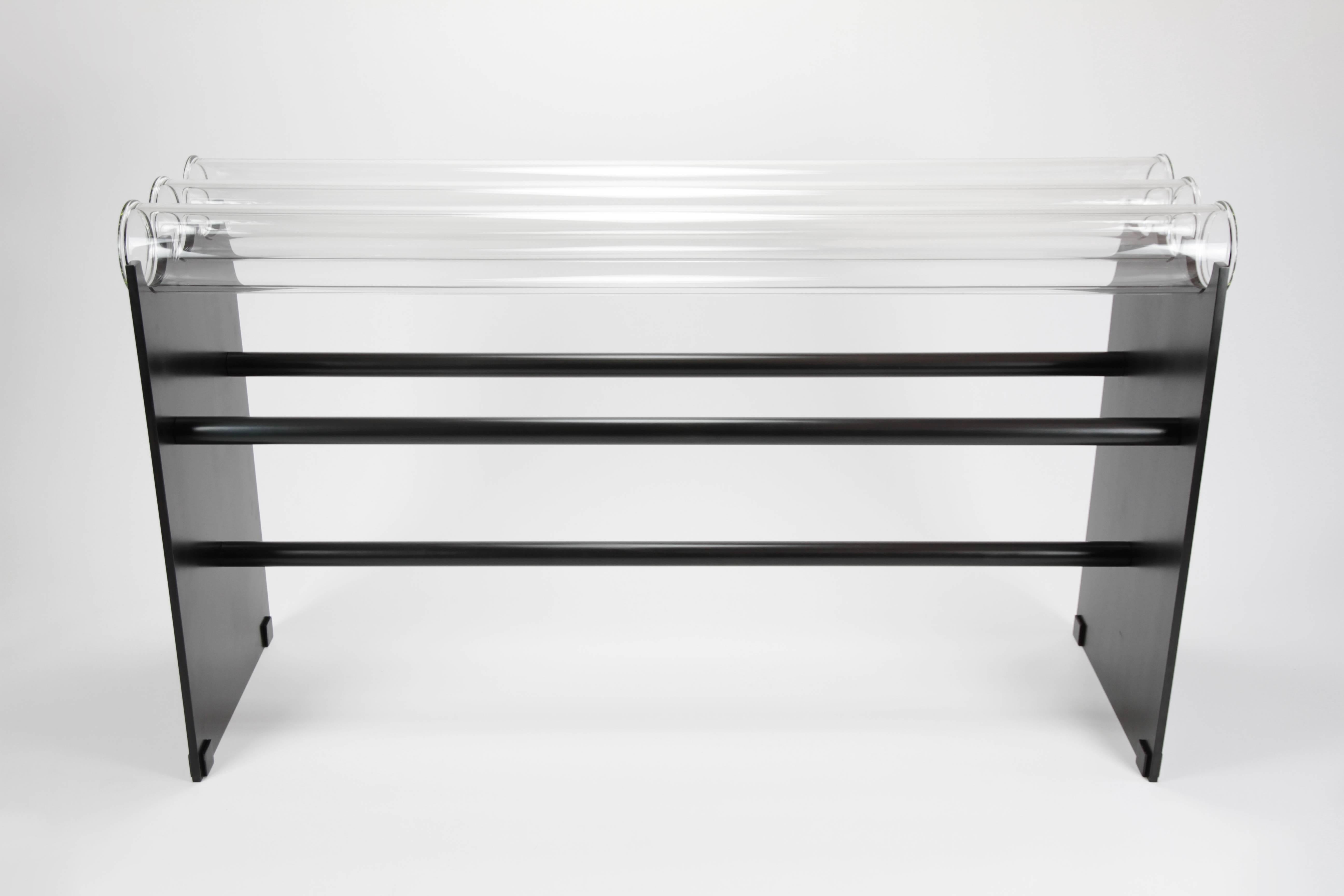The Museum console was inspired by the Museum bench (see separate listing) It's made of glass pipes, solid steel, and is strong enough to hold up to 250 pounds! 
The steel has a blackened patina that reads as a dark graphite gray in bright light and