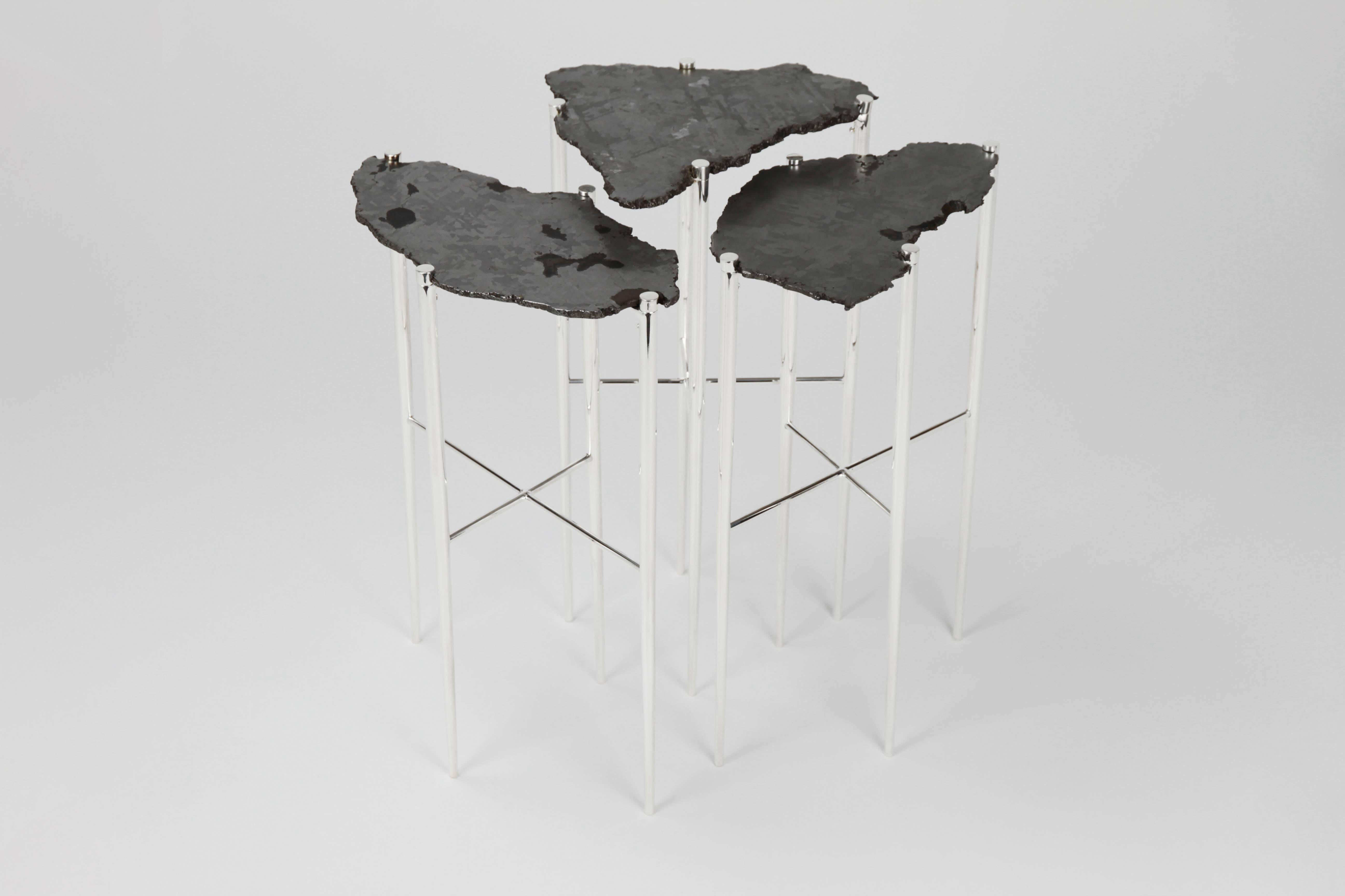 The Meteorite Cocktail tables are jewelry for the home.    
Selected etched cross sections of a 5,000-year-old Meteorite, found in Argentina, are placed upon handcrafted sterling silver plated brass bases.
The legs are individually turned, tapered,
