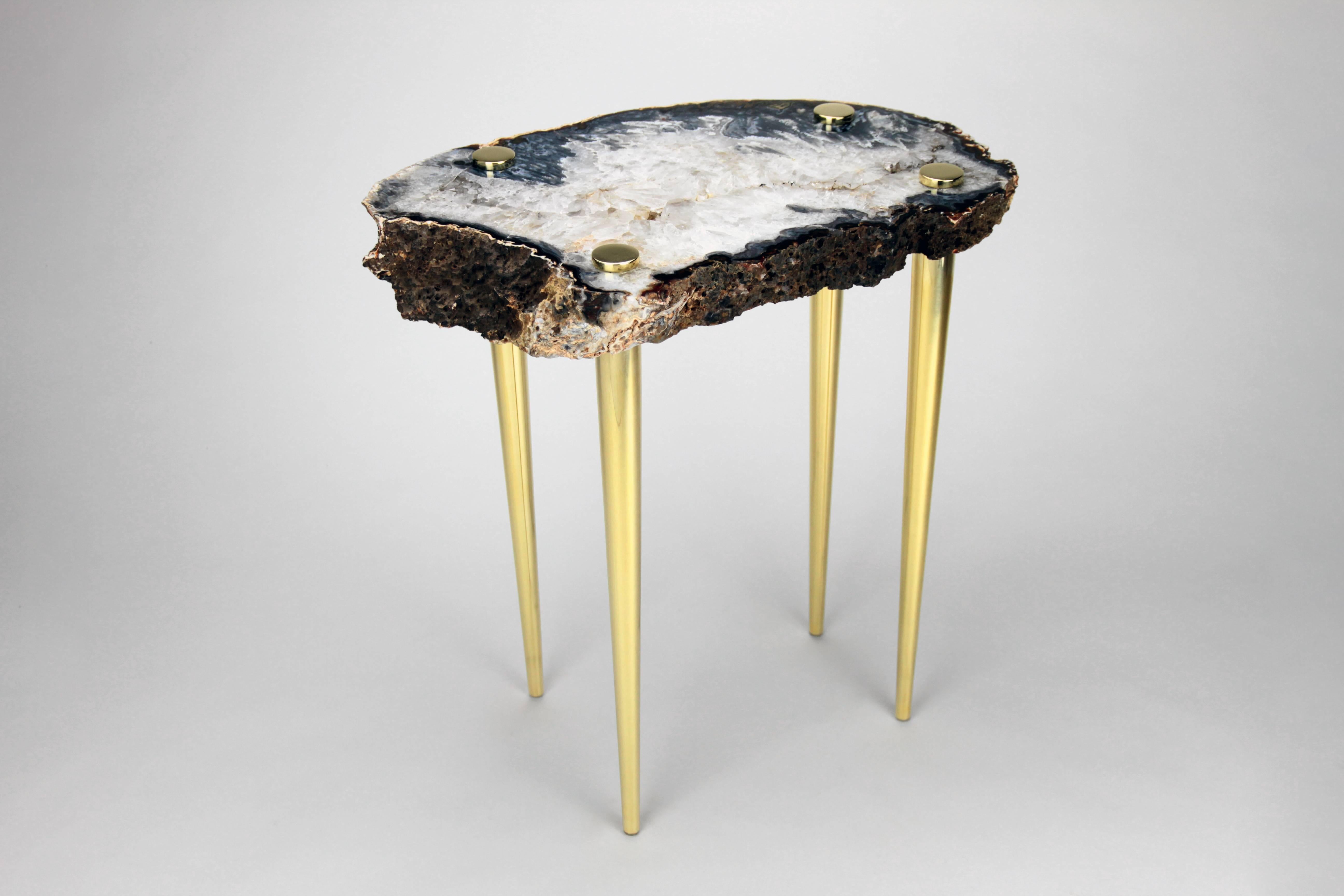 Zoom in and get lost in the beauty of this high polished natural quartz crystal slab table top that been pieced with solid brass turned legs. The stone looks like an image taken of Earth from Space. Dive in a bit deeper into the two craters that
