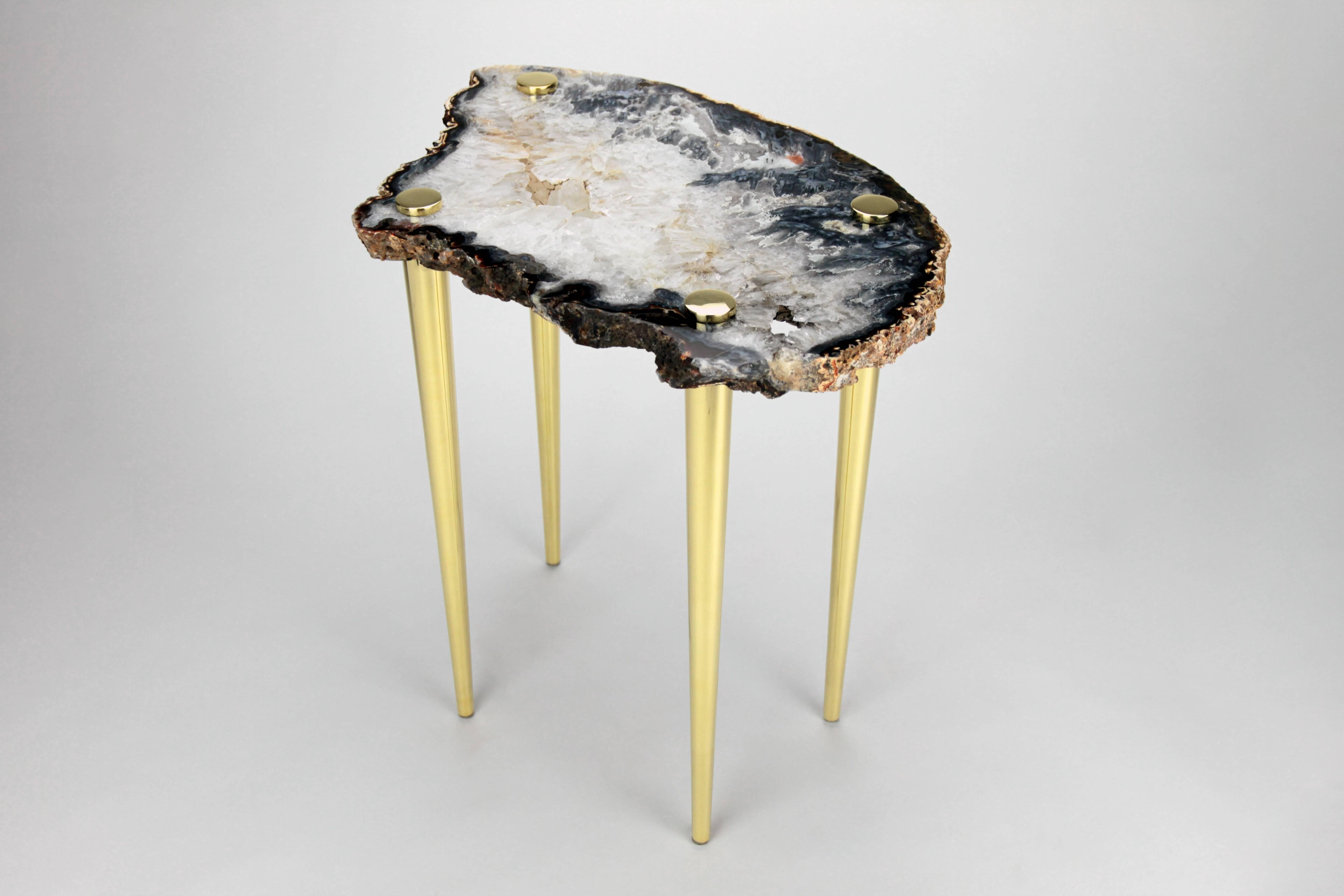 Zoom in and get lost in the beauty of this high polished natural quartz crystal slab table top that been pieced with solid brass turned legs. The stone looks like an image taken of Earth from Space. Dive in a bit deeper into the two craters that