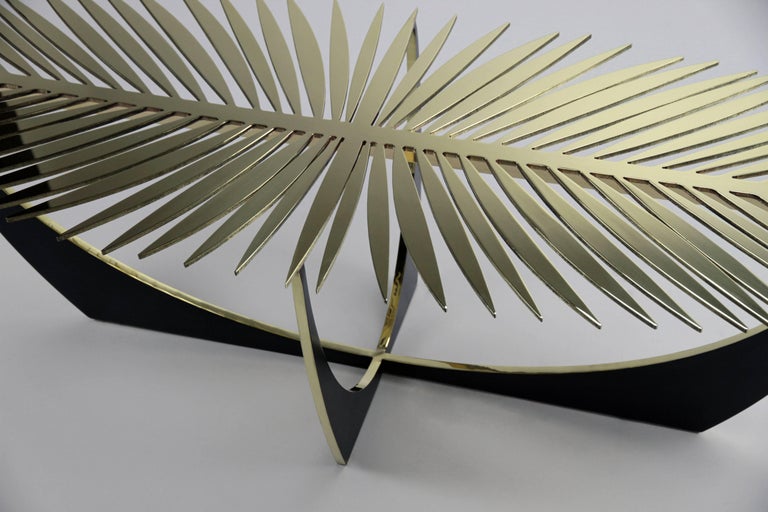 The double frond coffee table is made of solid brass.
The tabletop and edges of the base are high polished and waxed. The base sides have a blackened oiled bronze patina.
The table works well sculpturally without glass but can be ordered with a