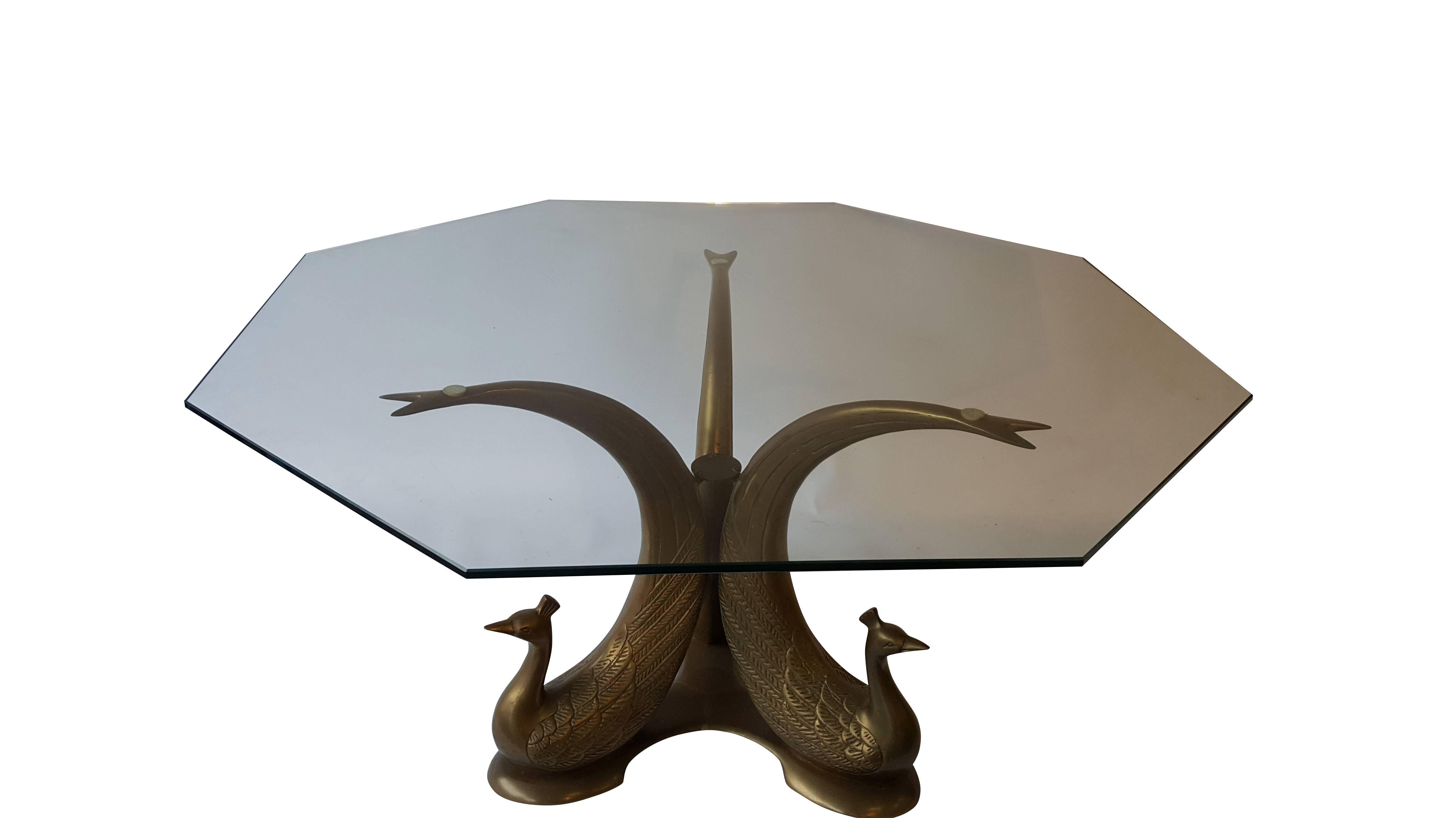 A very elegant Hollywood Regency coffee table!
Beautifully detailed ornate base brass, this table features three brass peacocks as the base.
The top is a separate and very heavy solid piece of round glass.
This piece is very heavy, sturdy, great
