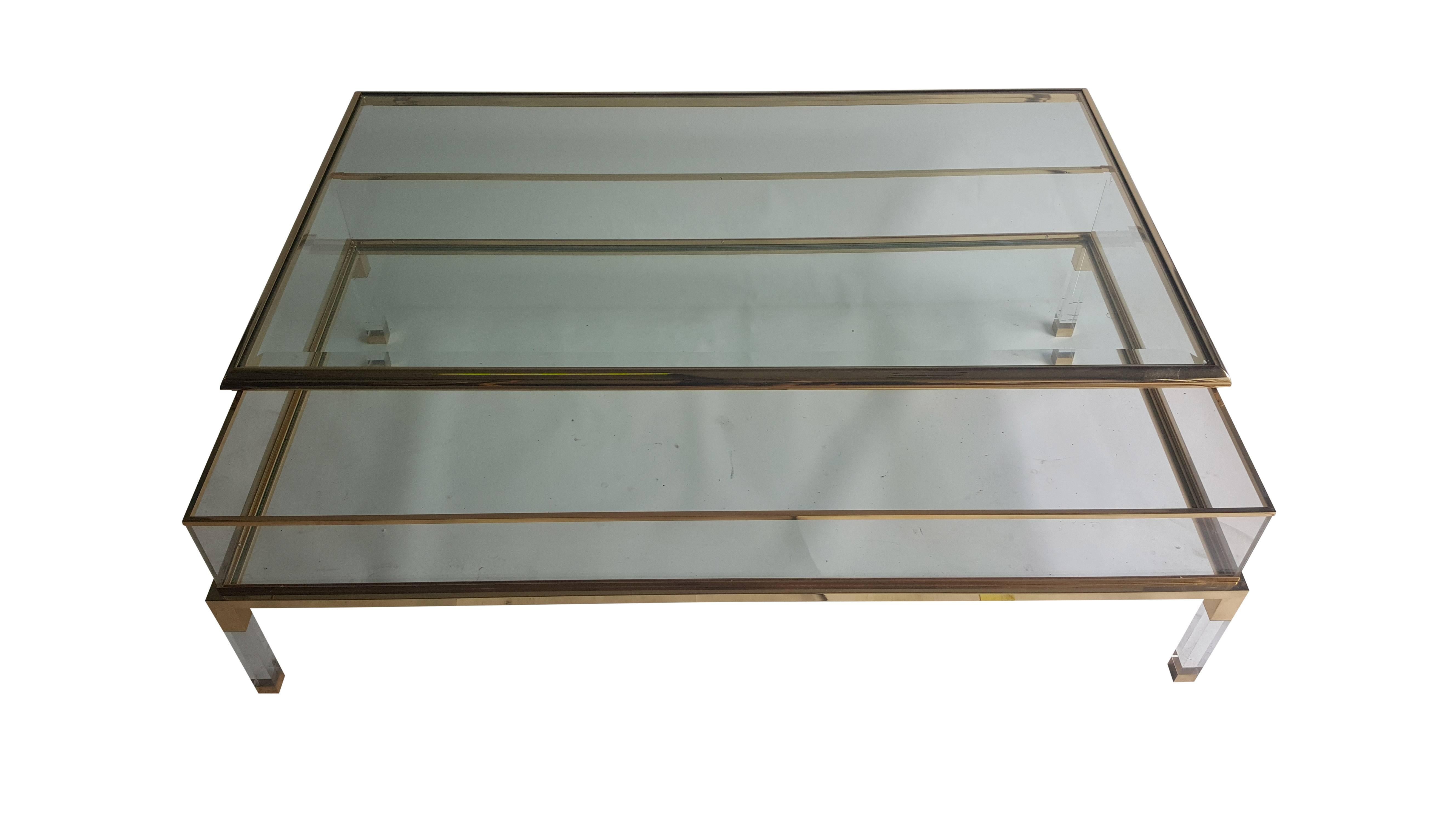 Large square glass table with sliding top by Maison Jansen. The table is made of Lucite glass and brass.
Made in France in the 1970s.