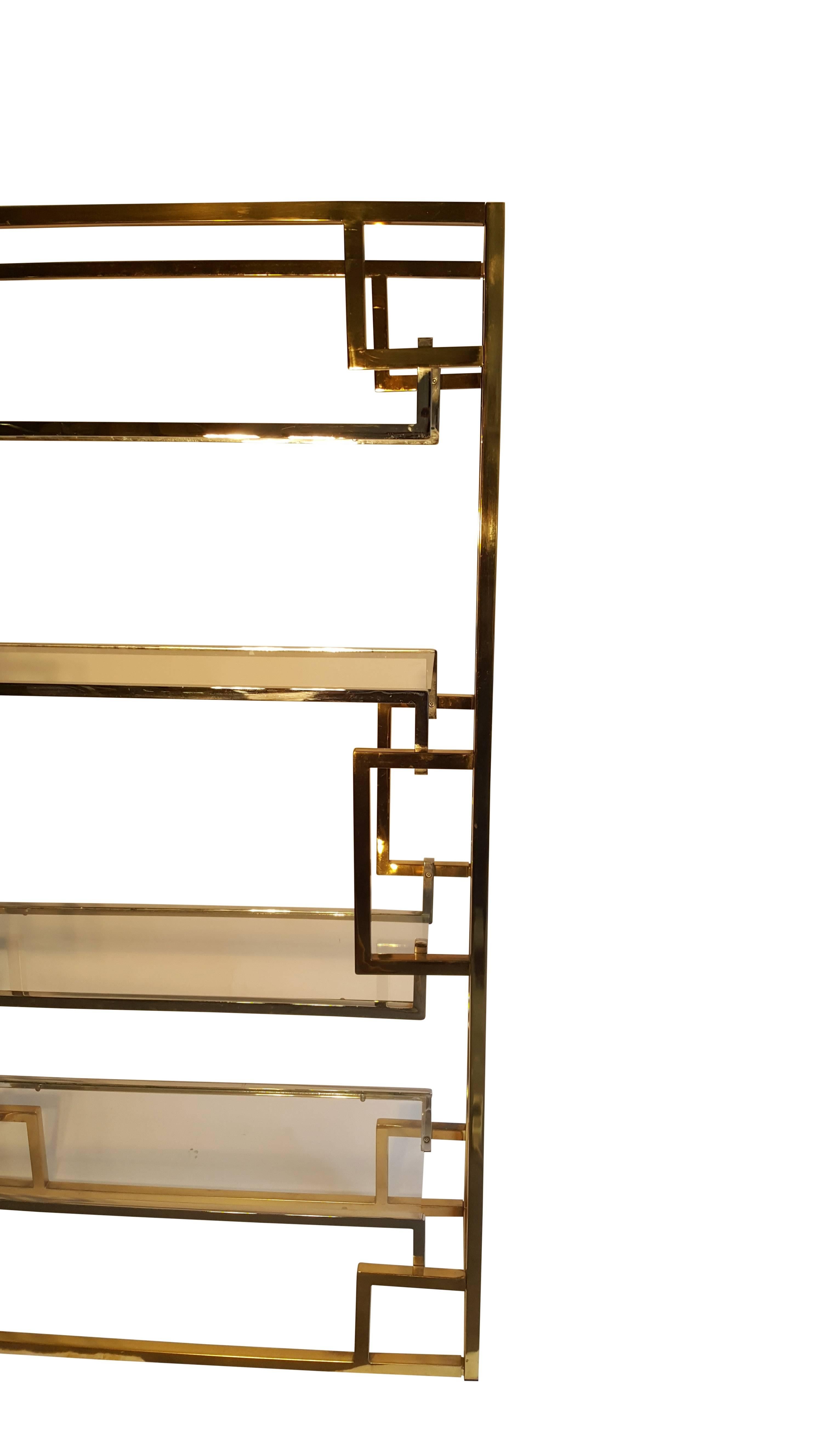 A good looking Hollywood Regency freestanding brass-plated etagere.
Architecturally in the style of Romeo Rega, Hollis Jones, Maison Jansen, Willy Rizzo.

We provided new glasses.
 