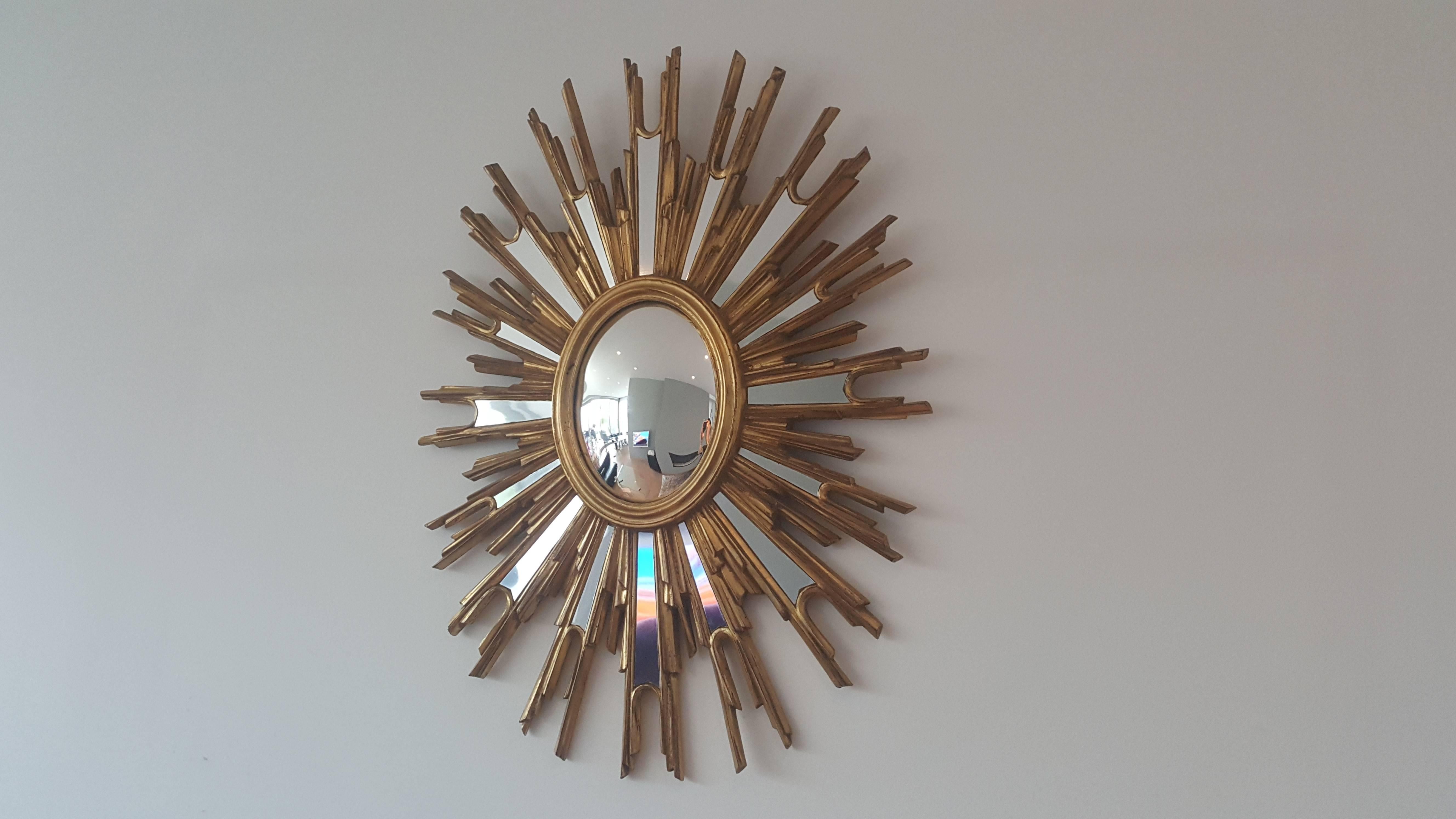 Extra large nice looking French gold sunburst mirror in wood with no defaults.
Made in France in the 1960s.