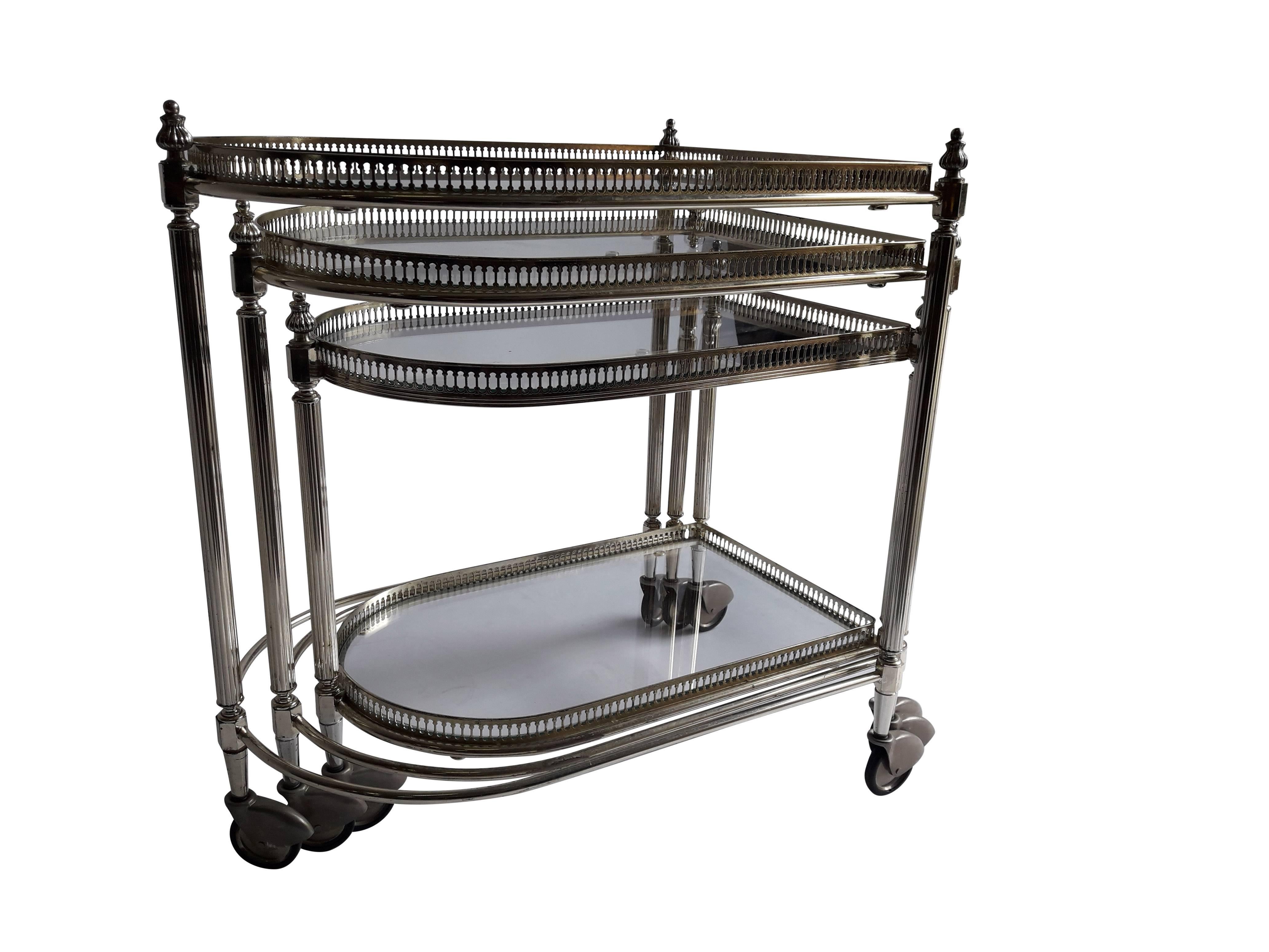 Set of three chrome nesting tables in the style of Maison Jansen, Italy
This amazing set of nesting tables are very much in the style of pieces created by Maison Jansen and date from the 1960s-1970s. 

Note: 
Dimension to top of rail on tallest