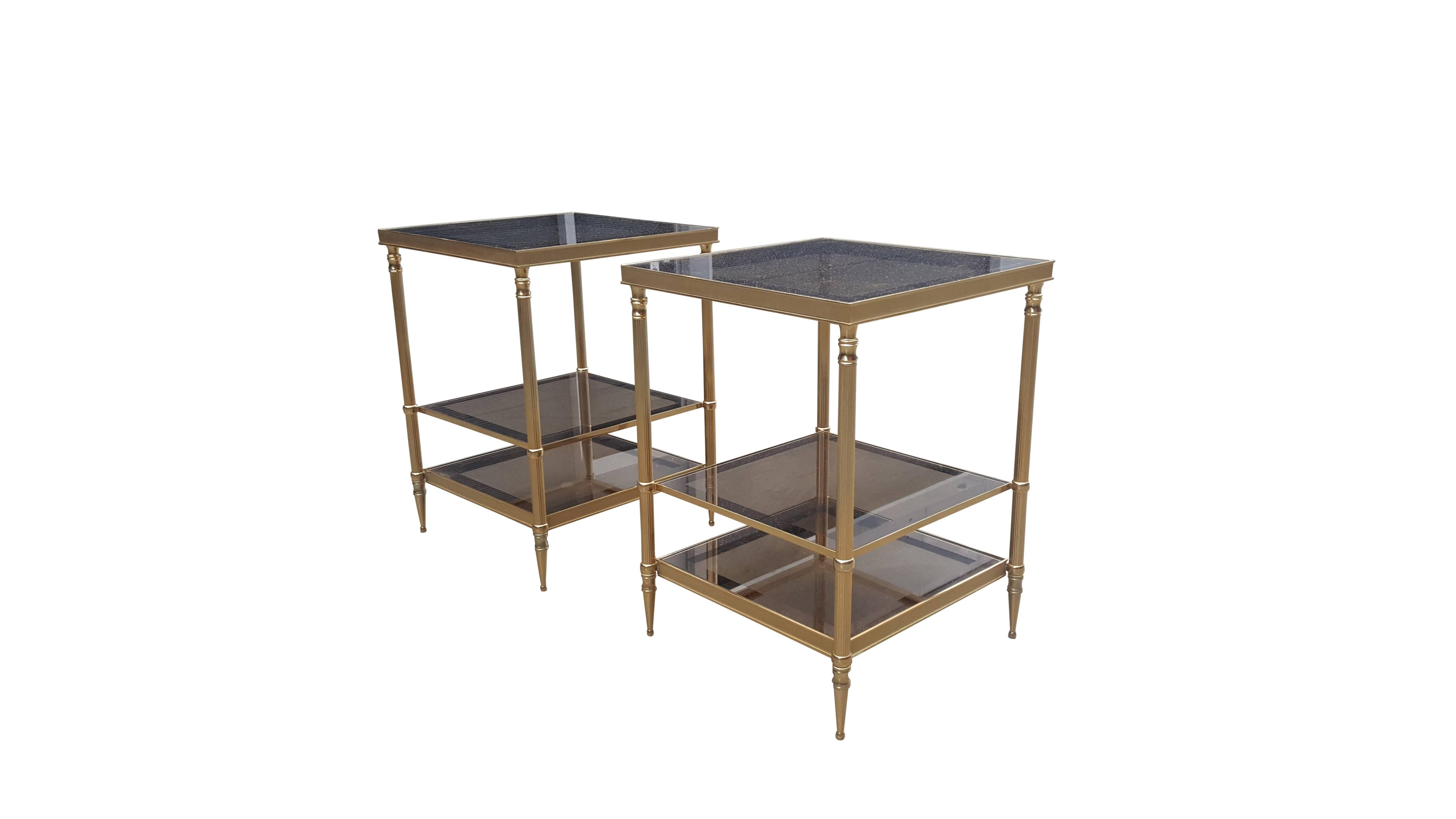 Pair of Mid-Century Modern Maison Jansen side tables, 1960s. 
Solid brass three-tiered end tables with glass tops. 
Elegant and functional design! 
In original condition with minor wear consistent with age and use!

Original glass!
 