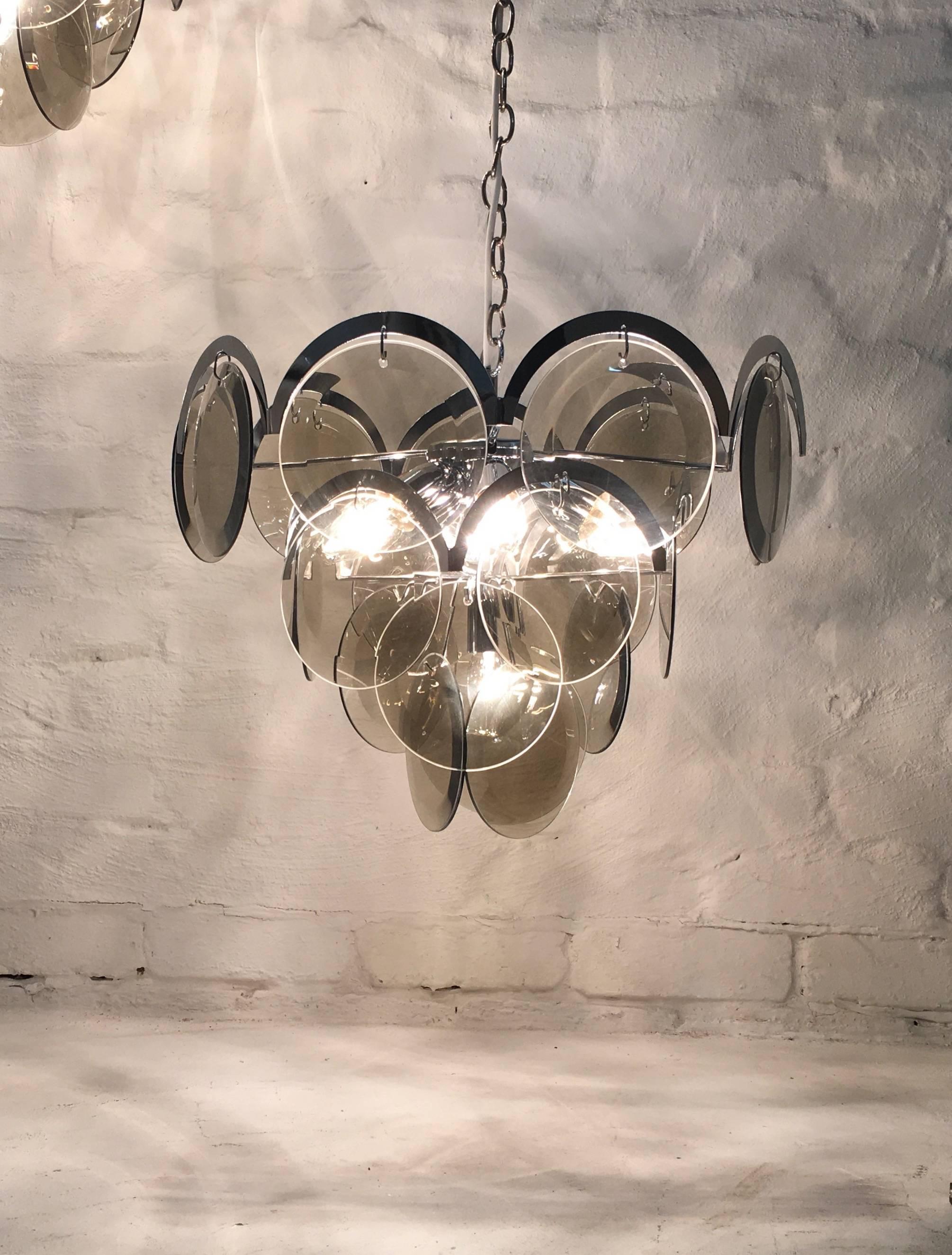 A superb four-tier chandelier by Vistosi, Italy, manufactured around 1978. In beautifully clean and sound condition. 

This item is the smaller of the two pictured and hangs lower in the images. A pair of the larger size is now listed separately on