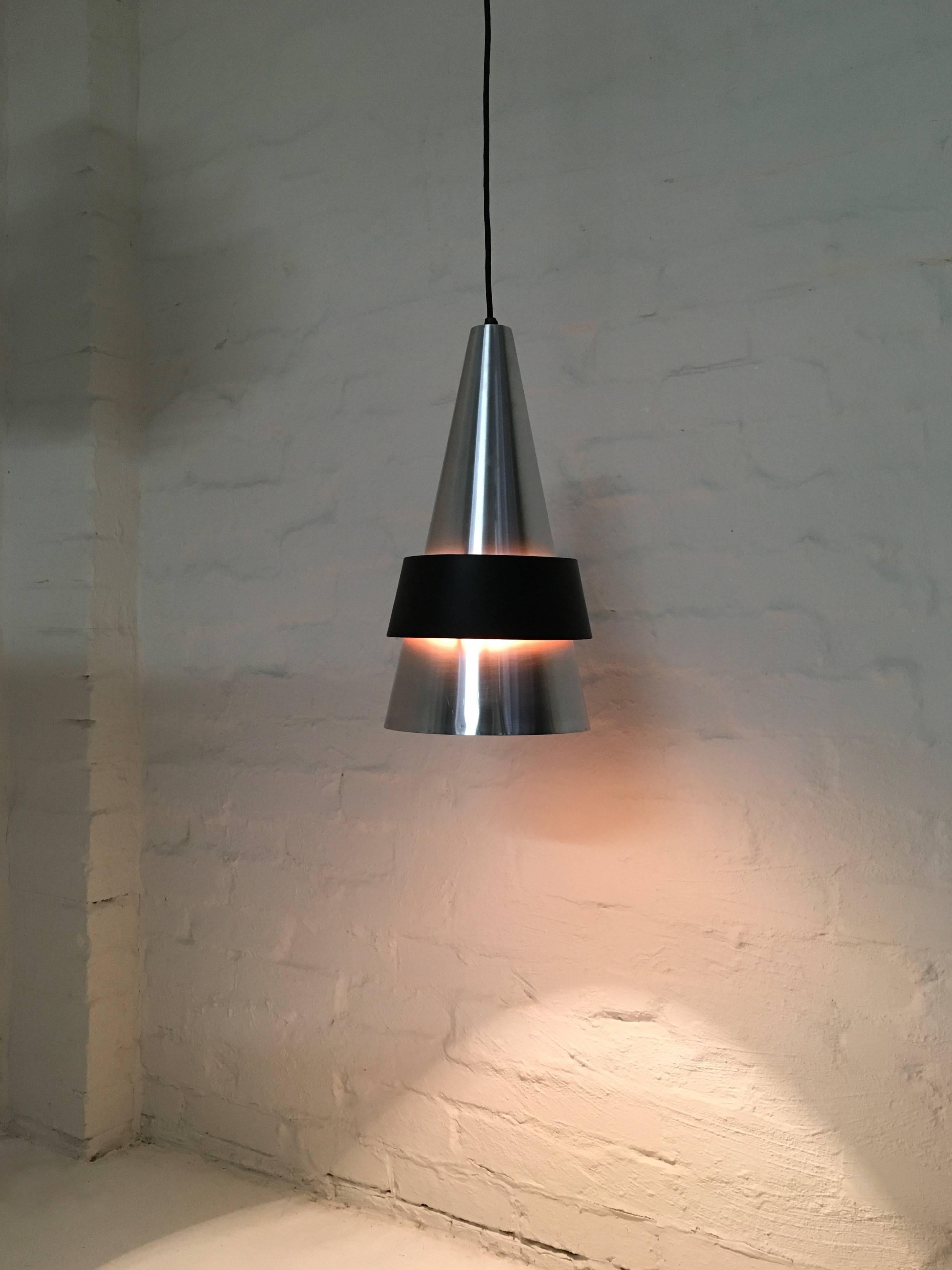 Jo Hammerborg's beautiful cone shaped Corona pendant was produced by Fog and Mørup in Denmark in 1963. Someone at that time in Australia took a liking to the design and had it reproduced in spun aluminium and steel, to the exact shape and size