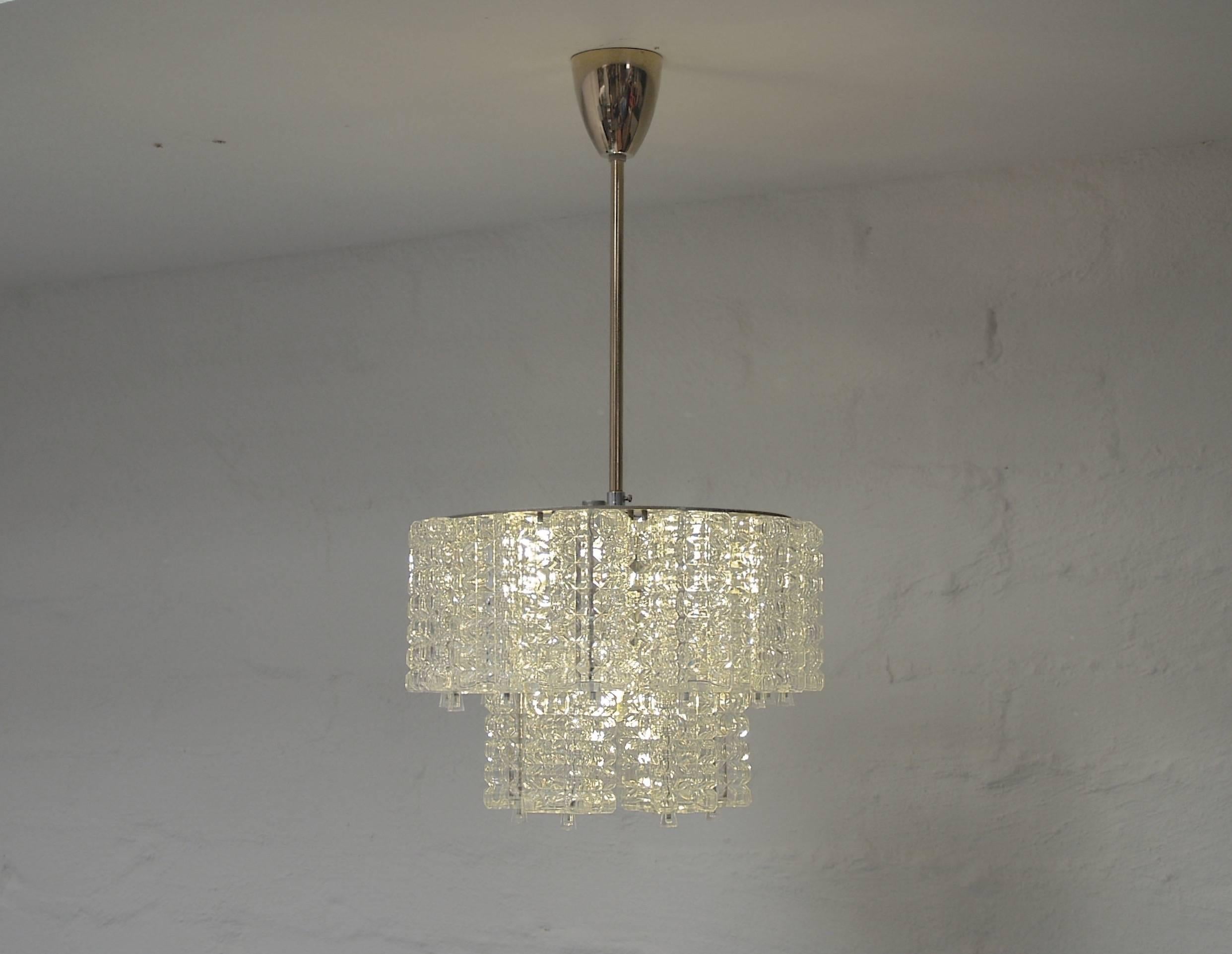 There is no hiding the shameless glamour of these petite chandeliers. Exceptional quality, painstakingly restored. They cast a lovely even glow.

Price for the pair. 

Two spare crystals come with each light. Nickel two-tiered gallery with chrome