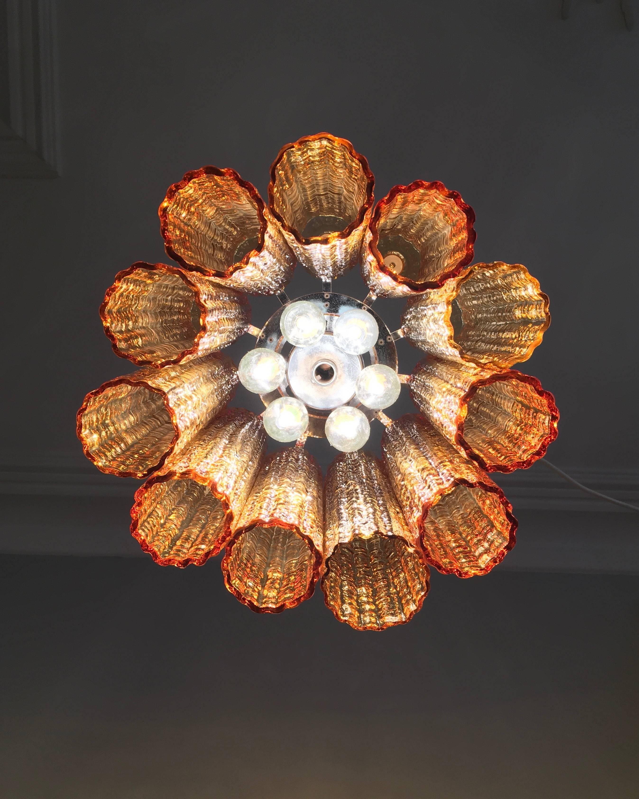 This lovely amber Murano Tronchi chandelier is a superbly simple and attractive light. Composed of 11 medium Tronchi glasses, it takes six small Bayonet cap candle globes.

Beautiful glasses all in fine condition. Measure: The glasses are 30cm
