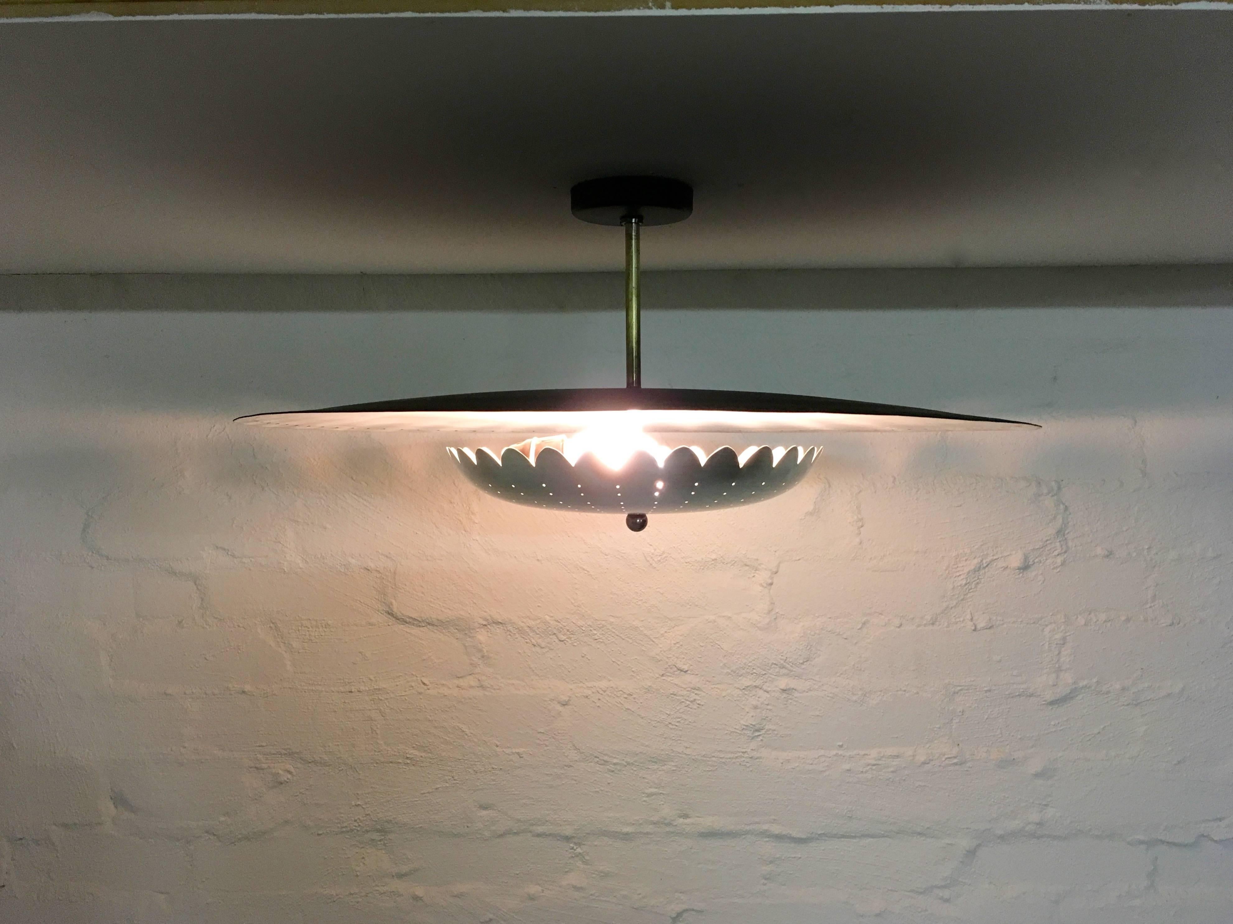 This feather-light ceiling fixture or reflector is a sweet Mid-Century number with some lovely period details - brass fittings, scalloped edges and a grand scale and proportion. It provides both ambient light from the large upper reflector and