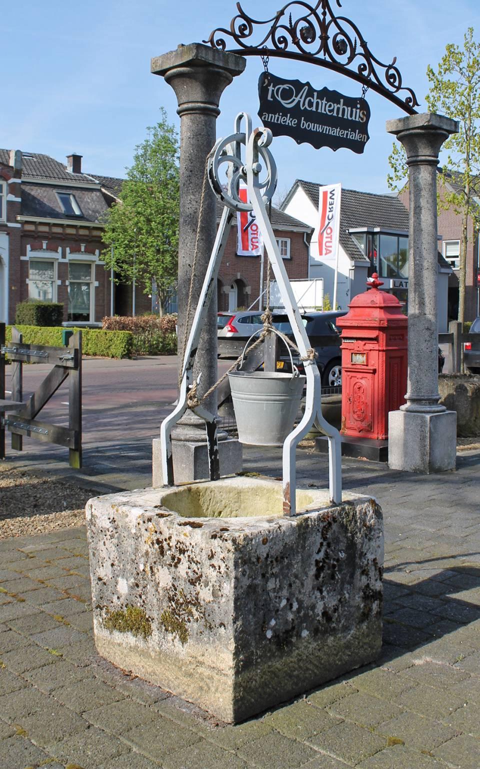 An antique well made from sandstone with an iron hinge and pulley.
A very beautiful garden ornament.