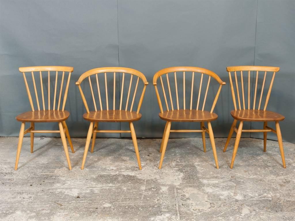 Set of four Ercol dining chairs. One pair of 'Cowhorn' Windsor armchairs and a pair of matching Spindle Back chairs designed by Luciano Ercolani for Ercol in the 1960s. Made from Blonde elmwood. In excellent vintage condition and recently restored.