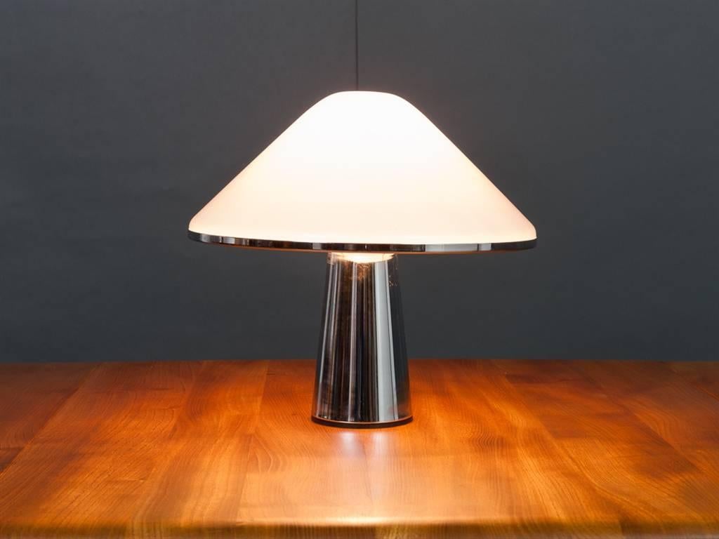 1970s chrome and Lucite small mushroom table lamp designed by Harvey Guzzini for IGuzzini. There is a slight indentation which is hardly noticeable in the very top of the Lucite mushroom canopy. It looks as though it was caused during the