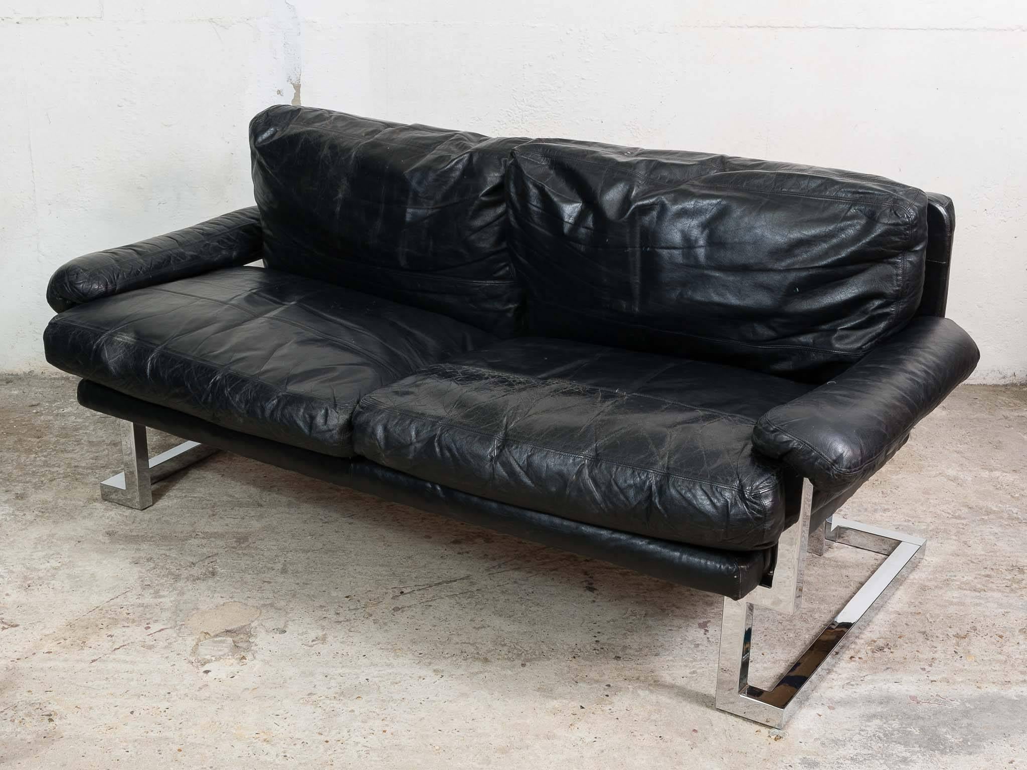 An iconic sofa designed in the 1970s by Pieff of Worcester. Pieff designed and manufactured furniture during 1970s. The chrome frame is in excellent condition. The original black leather is in good vintage condition with some age-related scuffs and