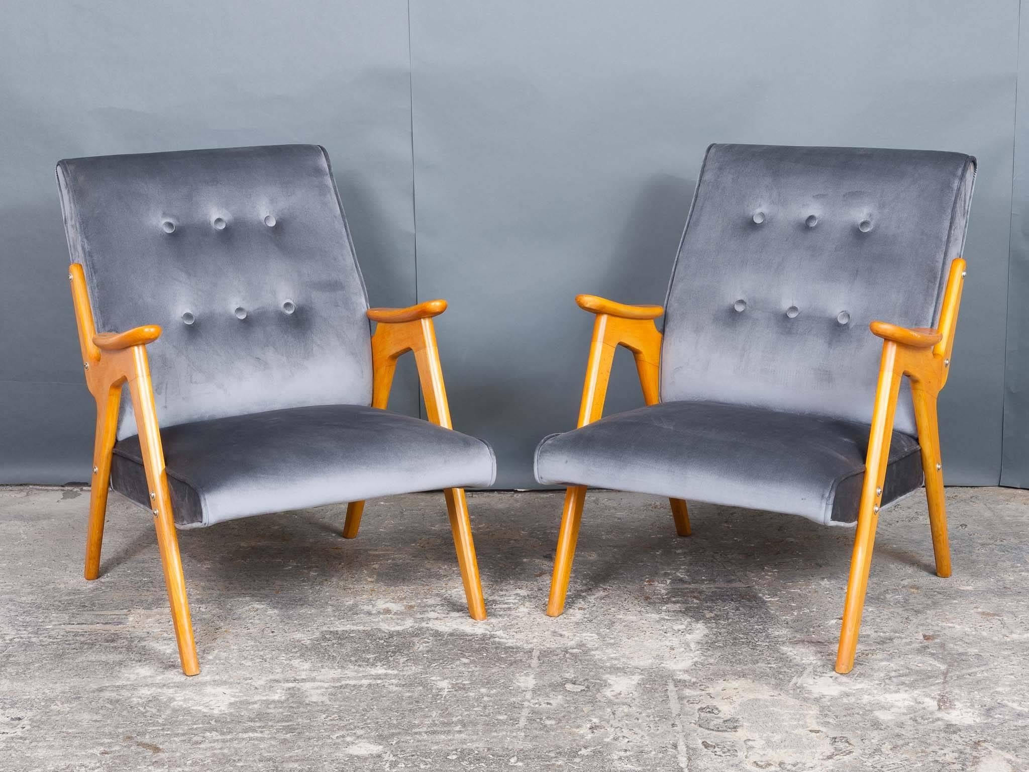 An unusual pair of stylish Czech cocktail lounge armchairs in the style of Jaroslav Smidek dating back to the 1960s. Recently refurbished and reupholstered in a plain grey deep velvet sheen fabric on a light wood frame. In excellent vintage
