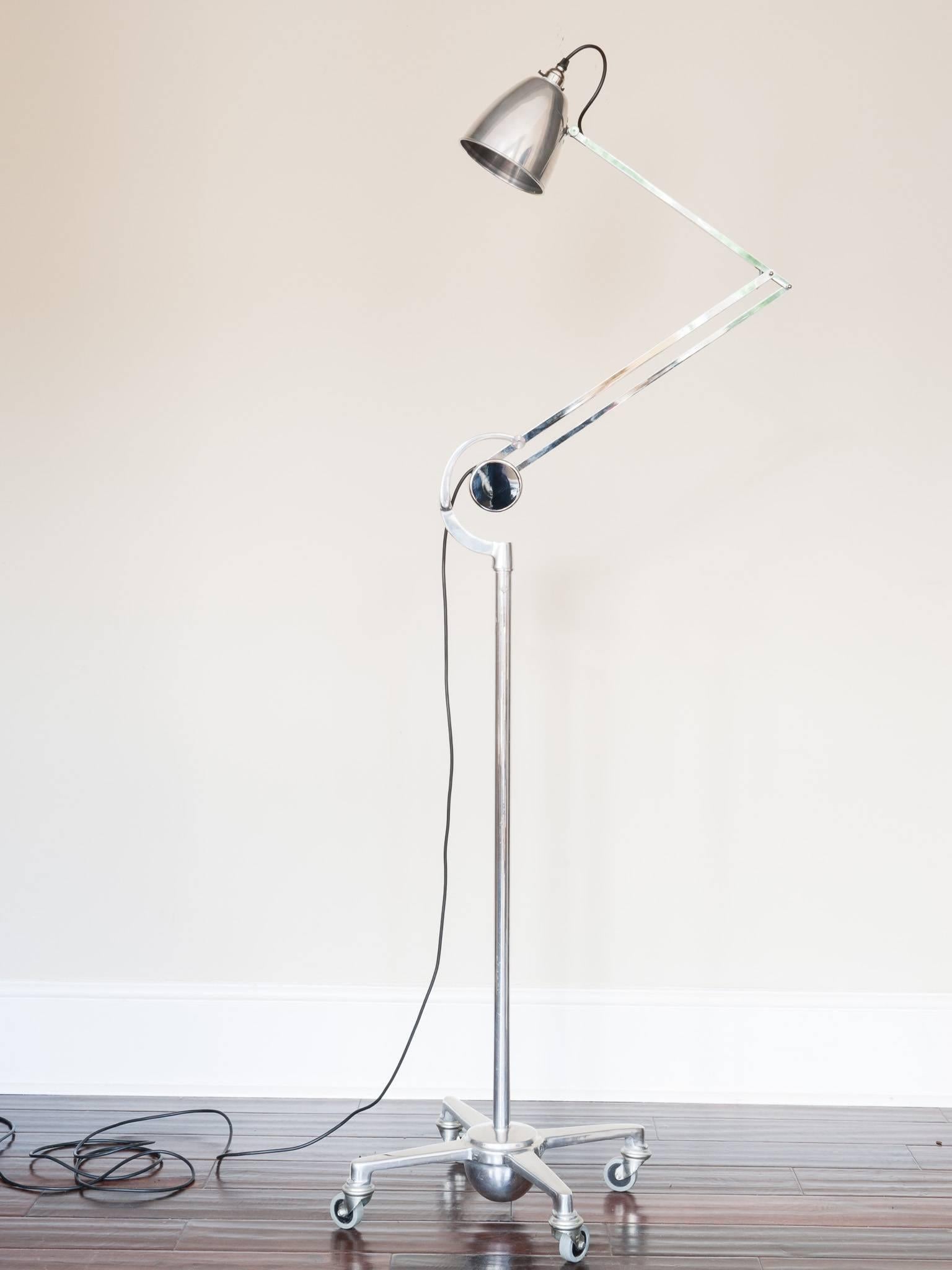 1950s British made fully-chromed counterpoise trolley floor lamp manufactured by Hadrill & Horstmann. The vertical rise separates into two pieces and is detachable from the base for ease of transport. The stand sits in a four-legged weighted base