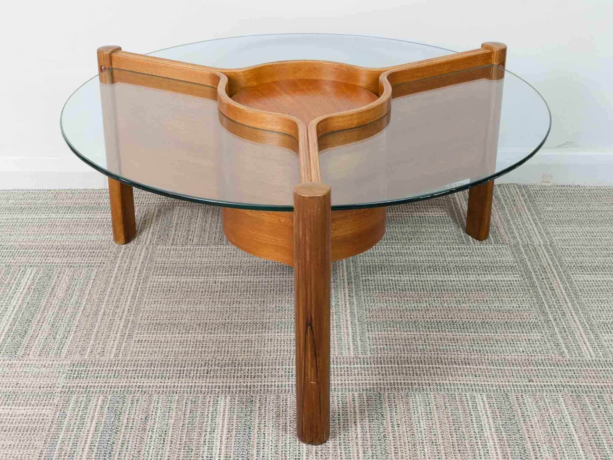 1960s Space Age coffee table manufactured by the English furniture maker Nathan. An interesting and well-designed round table made from thermoformed plywood with a central detachable tray. The table is composed of three separate glass sections which