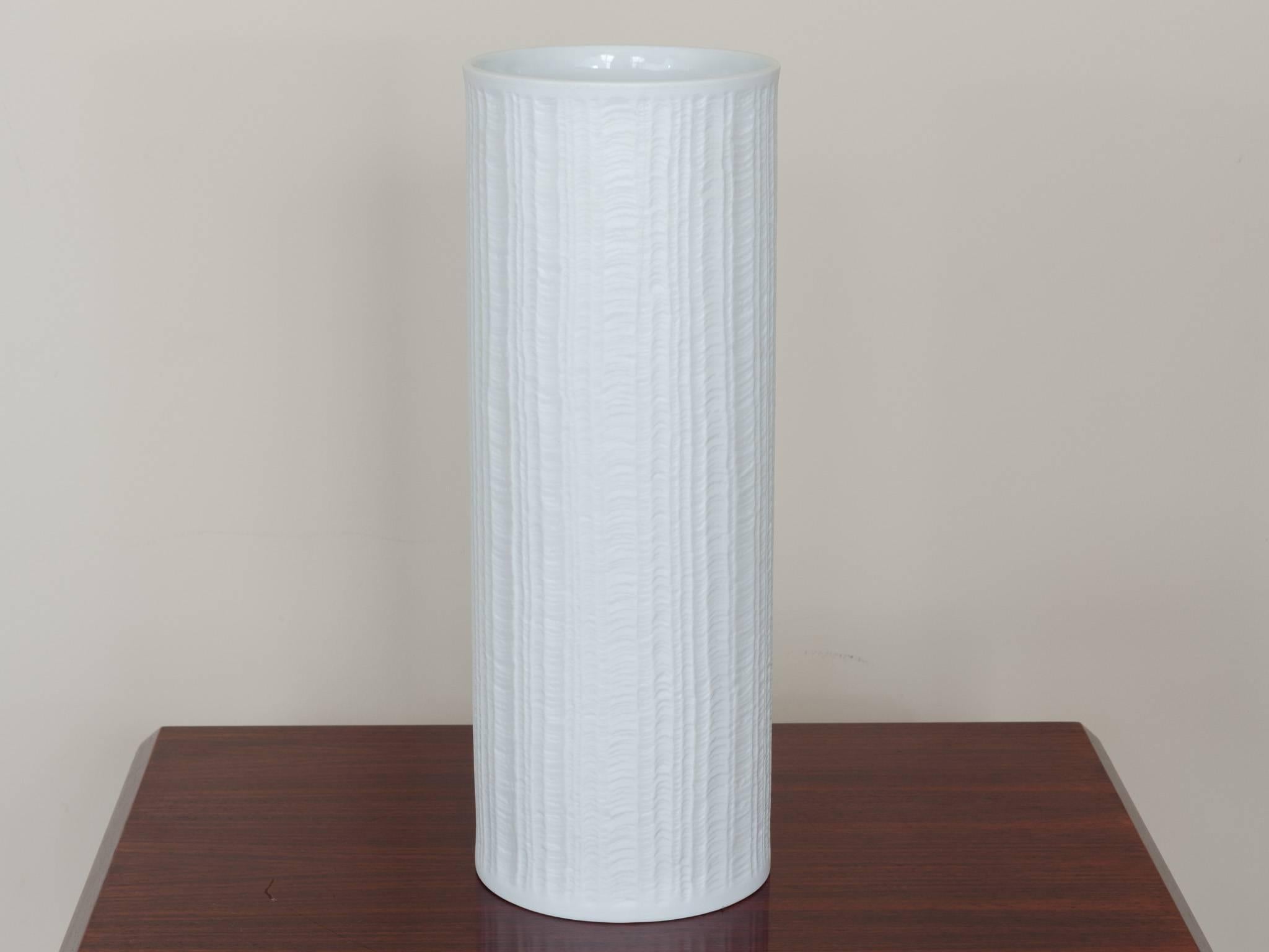 1960s Tall Bavarian Hutschenreuther matte white porcelain vase with vertical waved indented abstract lines running up and down the exterior. Marked on the base 1814 Hutschenreuther, Germany. In excellent vintage condition.