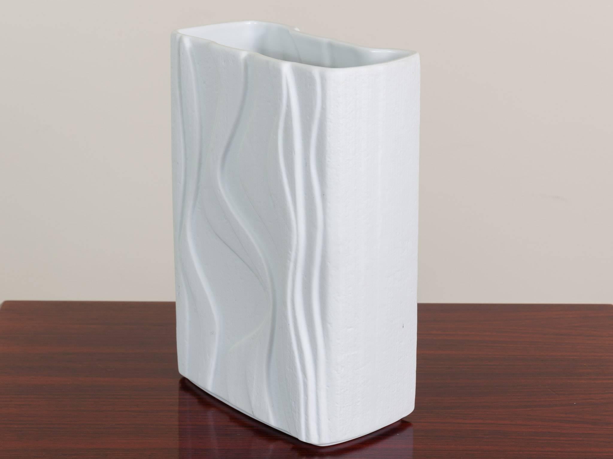 1970s 3-D raised abstract textured bisque white porcelain vase by Heinrich & Co, Selb, Bavaria, Germany. A very clever and unique design which gives the illusion that water has run down it to create the pattern that would be left on the beach in