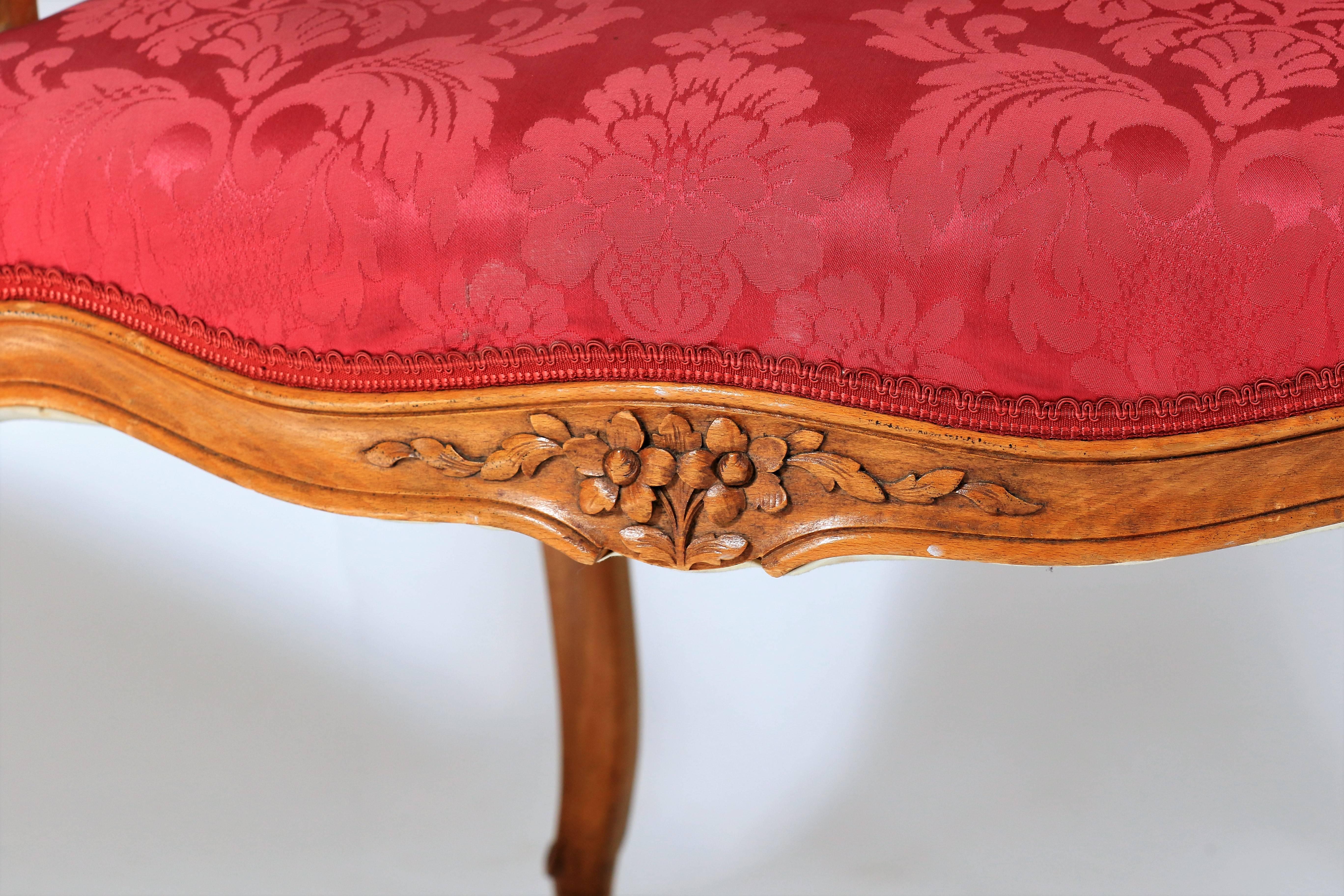 19th century pair of armchairs carved Louis XV style with floral motifs and covered with a nice raspberry tissues.
 