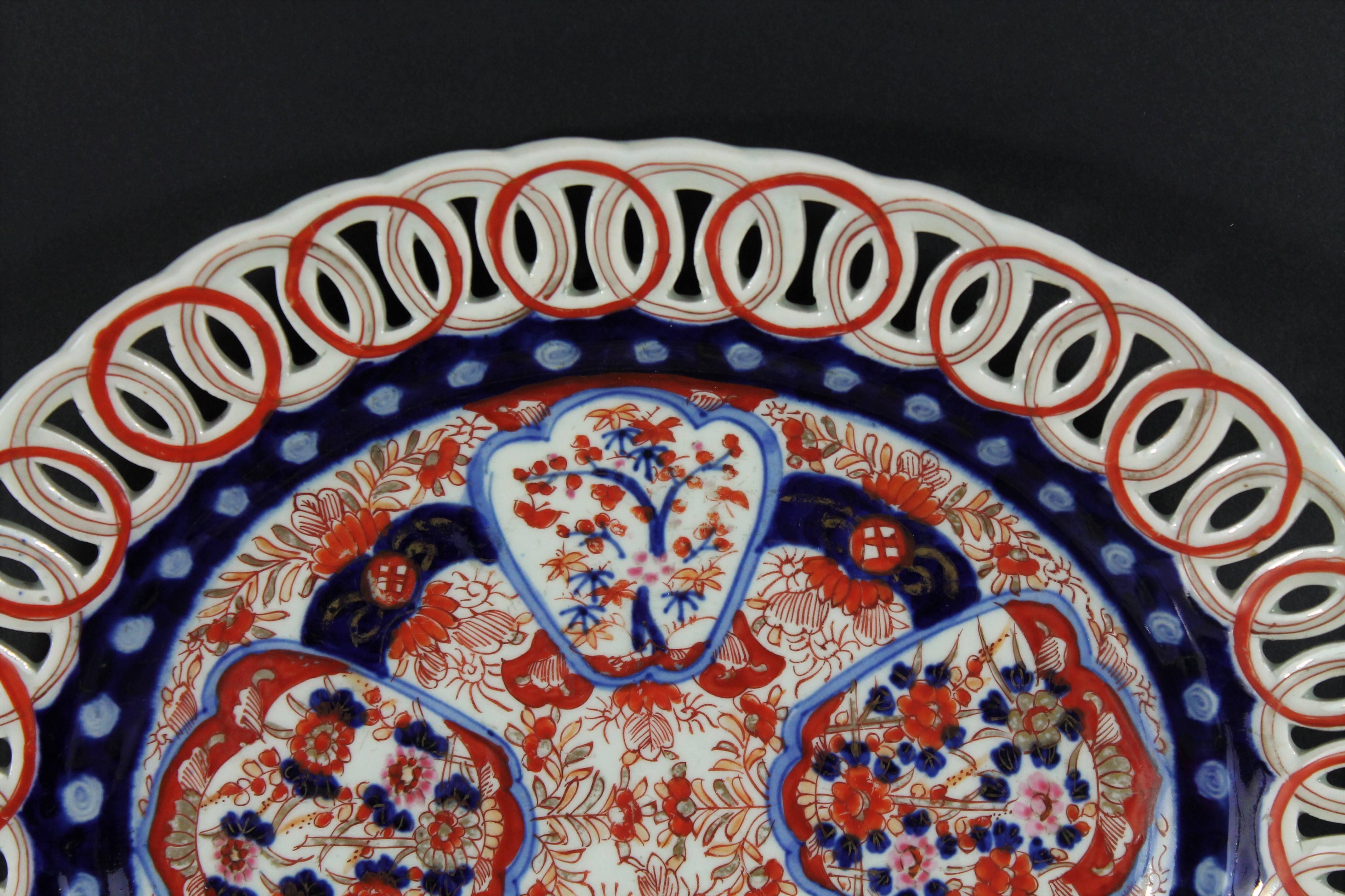 Imari or Arita plate decorated with flowers or trees in reserves and openwork edges,
Japan,
early 20th century.
