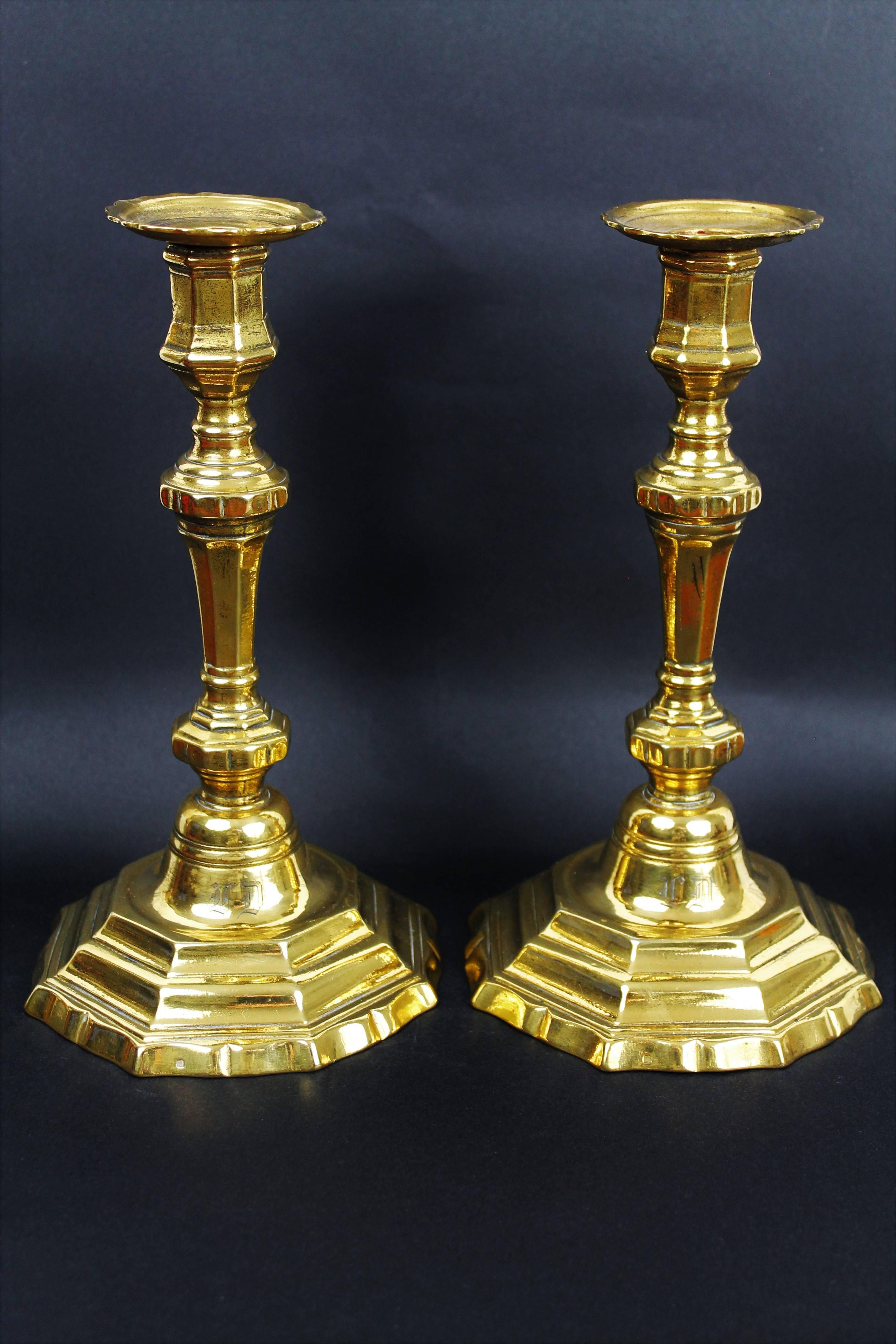 Pair of bronze candlesticks in Louis XVI style with a monogram on the base in Gothic letters,
France,
19th century.