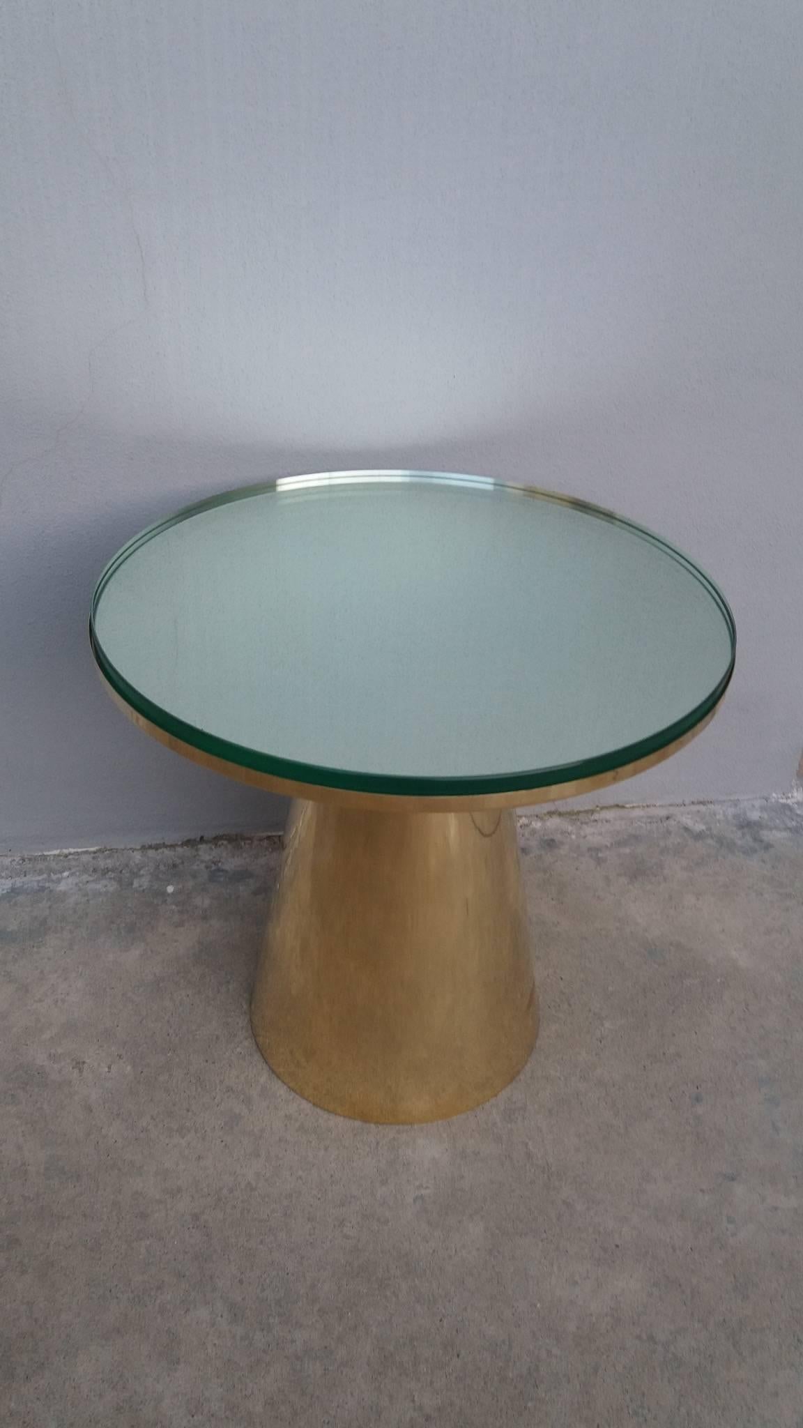 Contemporary decoration coffee table of brass and gleaming glass.