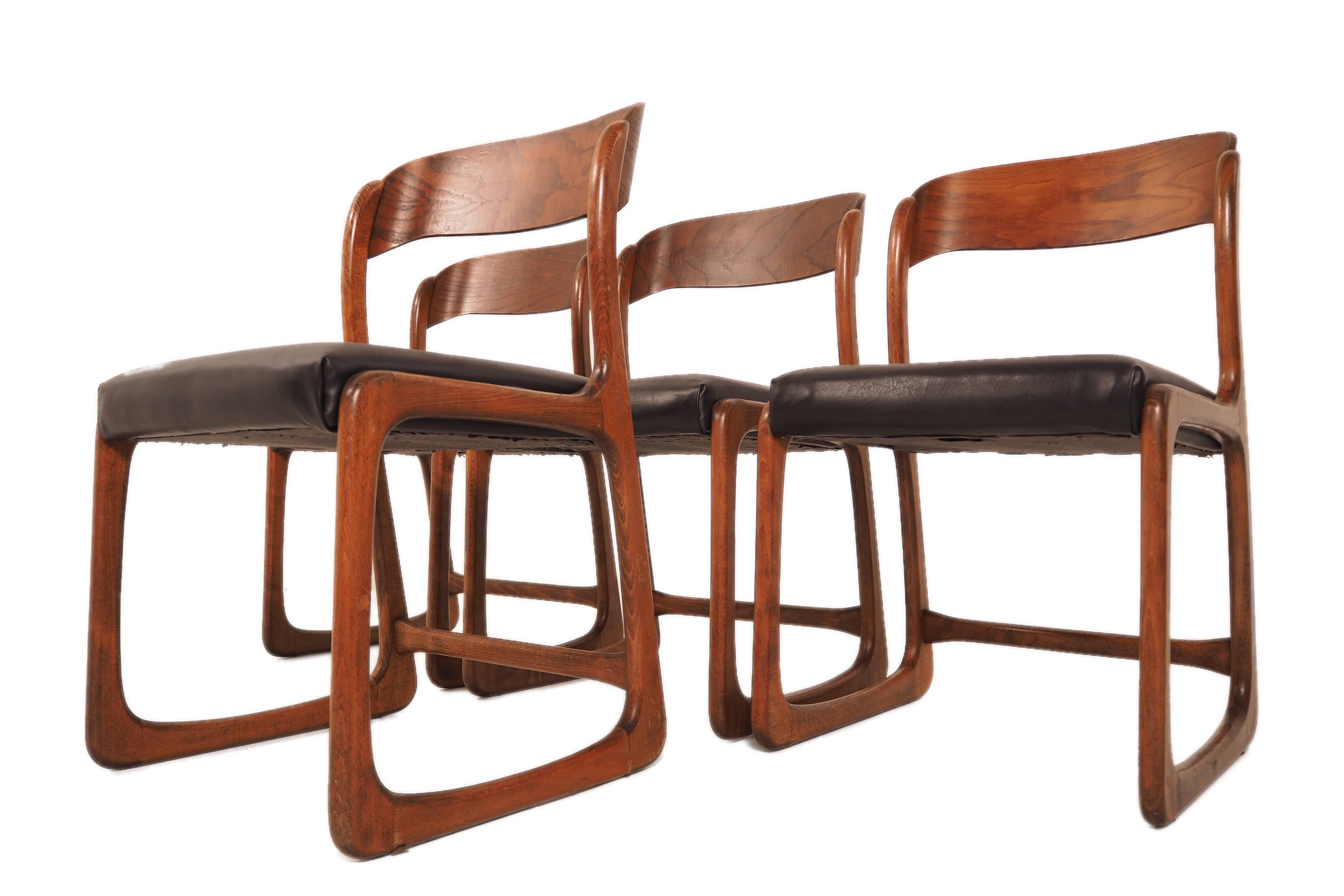 This set of four vintage dining chairs were designed in the 1960s and probably manufactured by Baumann in France. They are made from beech and have been upholstered with black leatherette. This set remains in a good vintage condition.
     