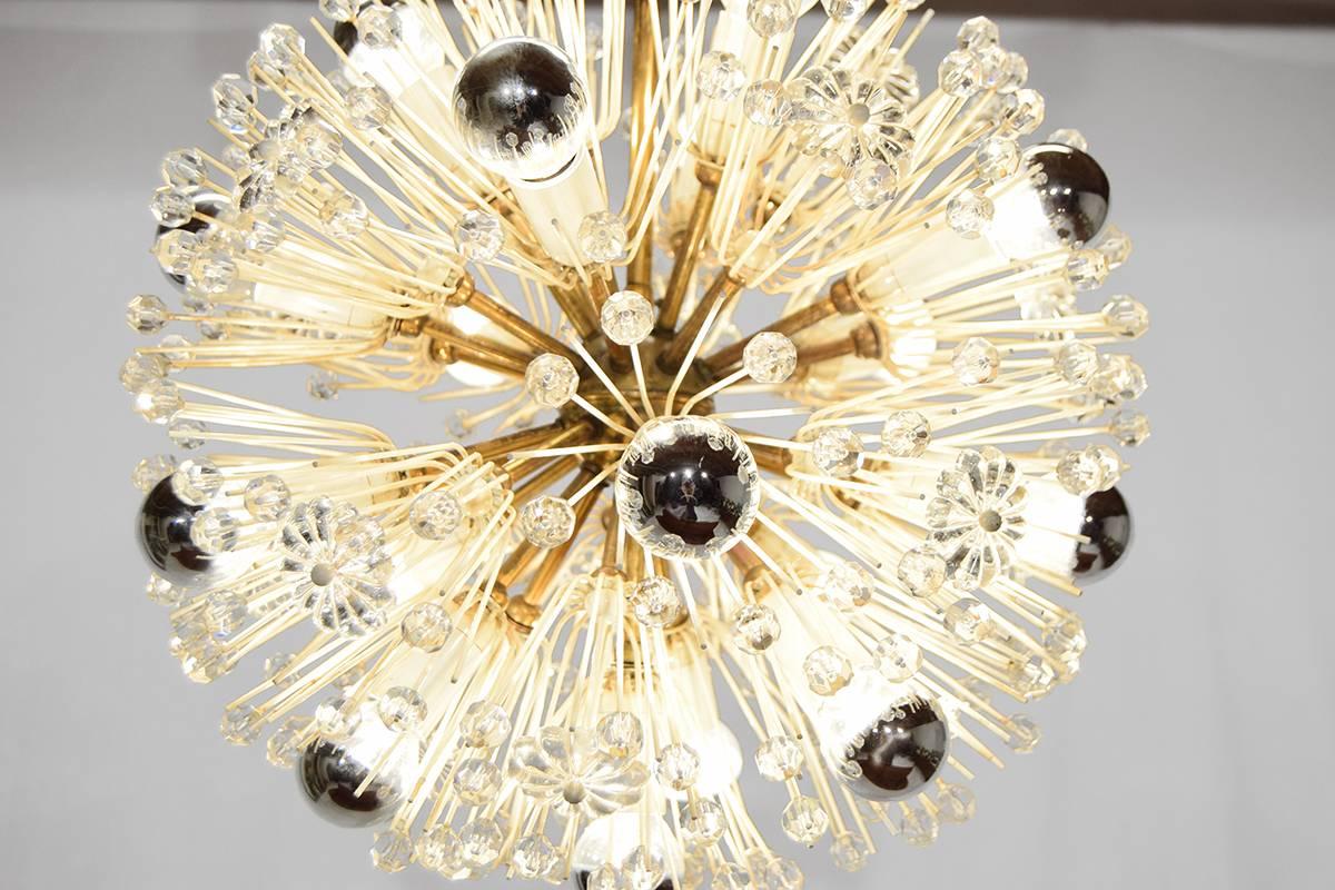 This glass and brass snowball chandelier was designed Emil Stejnar for Rupert Nikoll in Vienna, circa 1950. The overall height can be adjusted.