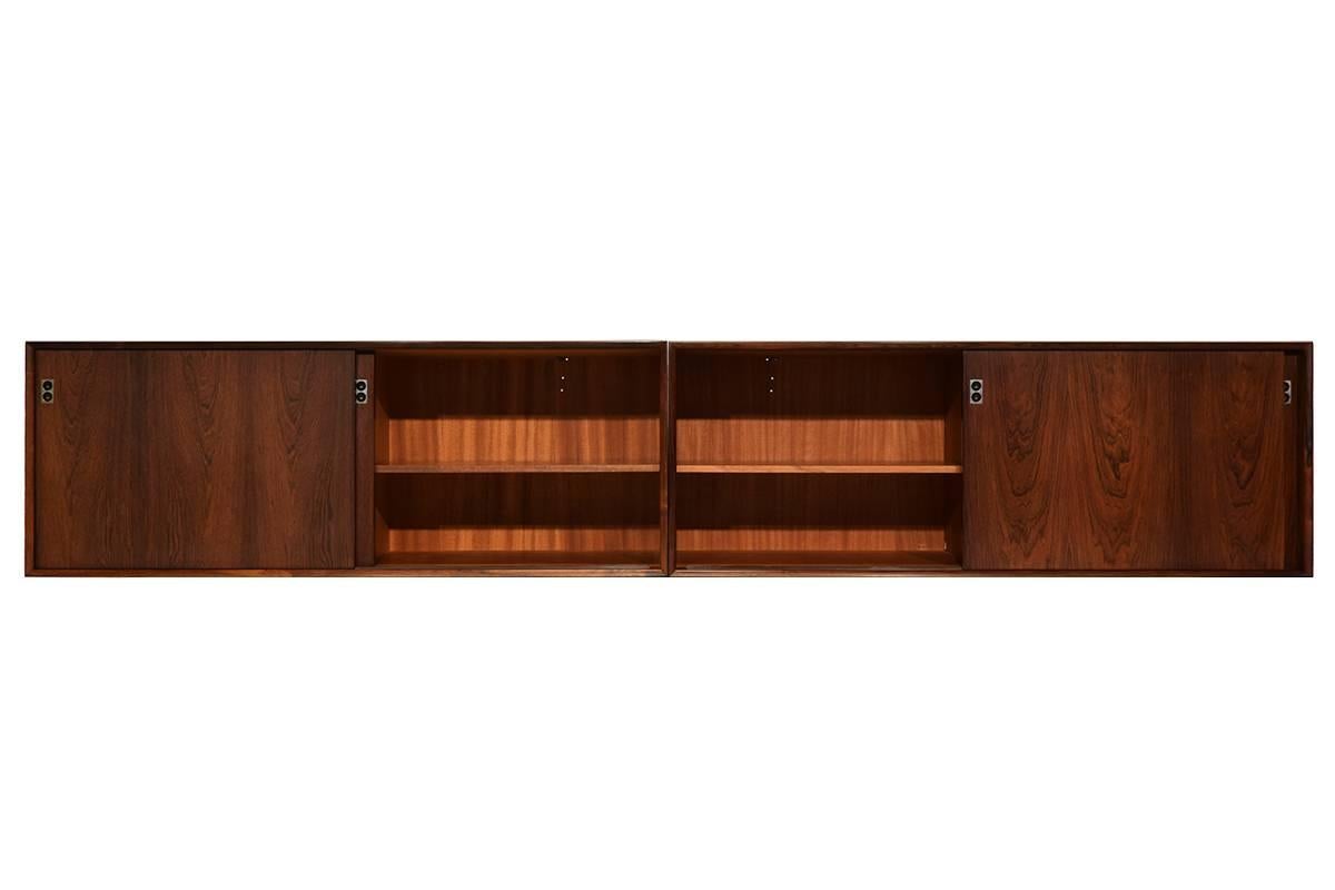 Very rare Danish Modern wall-mounted sideboard. Designed by Arne Vodder for the Danish Sibast.
The two sideboards are in an excellent state. Sibast used High quality rosewood veneer and solid rosewood elements. The sideboards are 150cm wide, in
