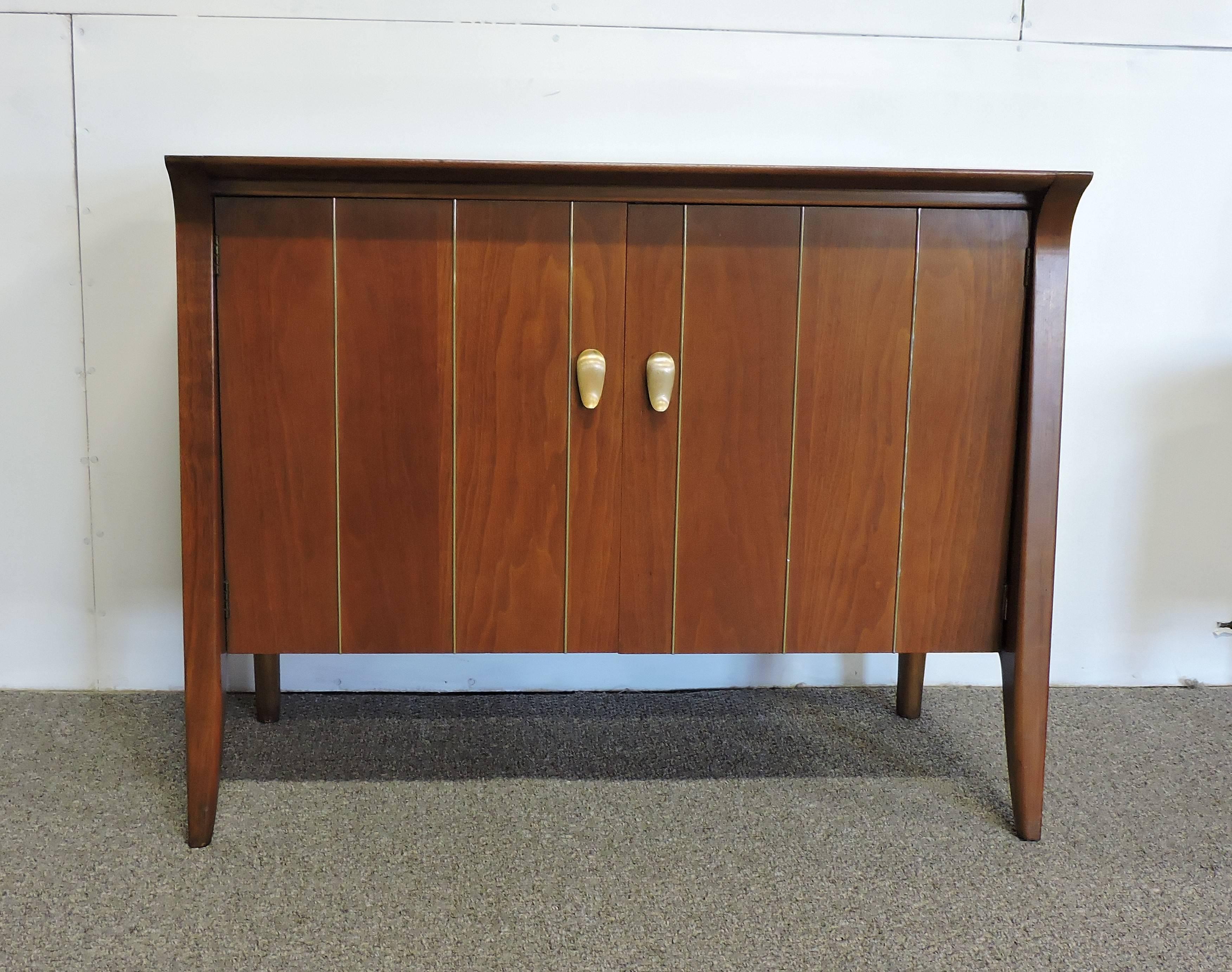 Beautiful Mid-Century walnut cabinet designed by Jon Van Koert and made by high quality furniture maker, Drexel. This cabinet was part of its profile collection which was made between 1955-1961. This cabinet has a unique look with an angled design,