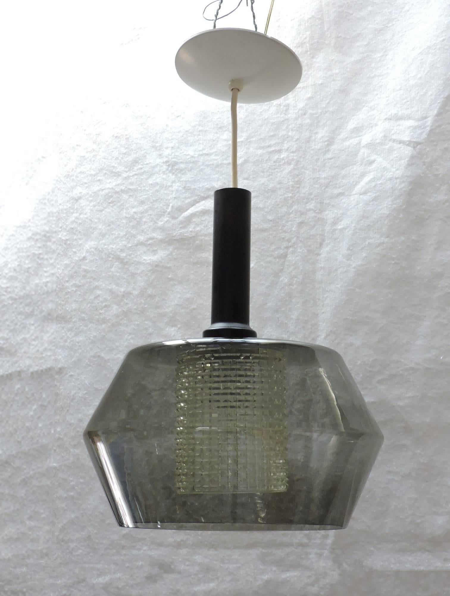 Handsome geometric Mid-Century pendant light made by high quality lighting manufacturer, Lightolier. This light has an interior clear textured glass shade surrounded by a larger smoked gray glass shade. This is very similar to light fixtures