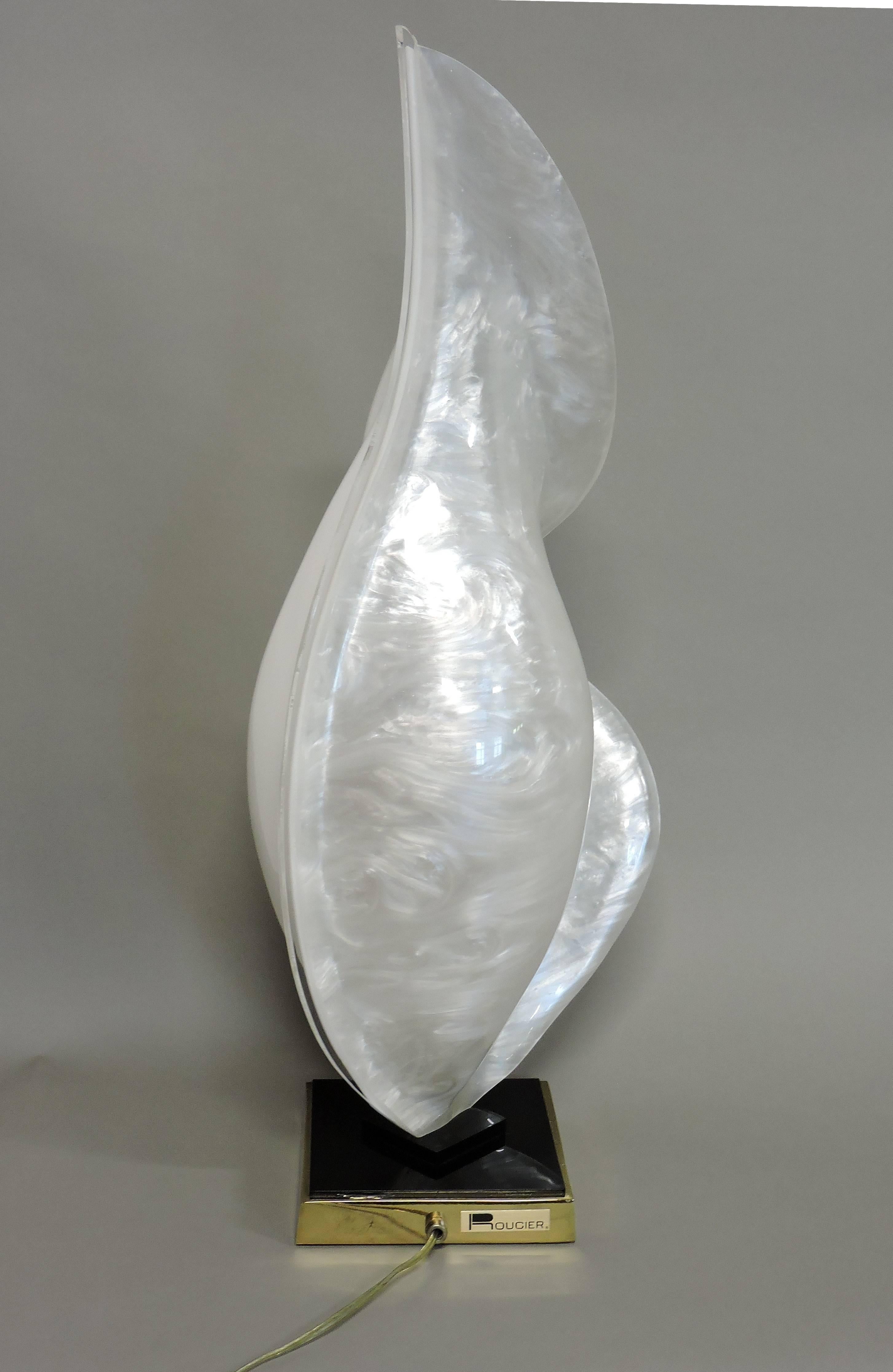 Unique free-form table lamp made by Rougier of Canada. This lamp is a combination of solid white and pearl white acrylic molded into a beautiful flowing shape. It has an inline on/off switch and takes a single bulb. Marked with Rougier label on base.