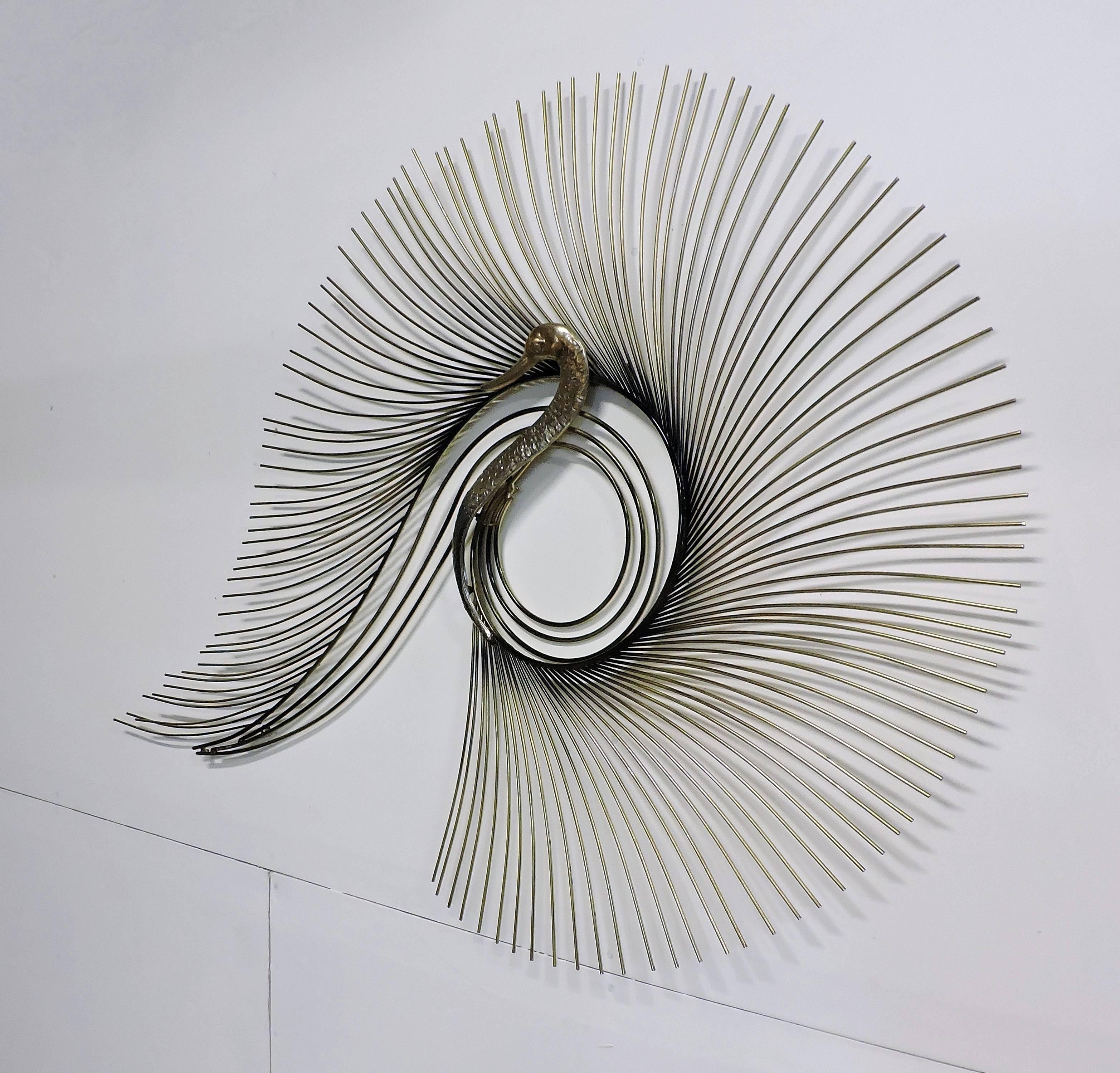 Large and striking brass wall sculpture designed and made by Curtis Jere. This sculpture has a cast brass peacock head with thick brass rods curved in a fan to make a stylized tail. Selective areas of black patina highlight the form.
Signed C.