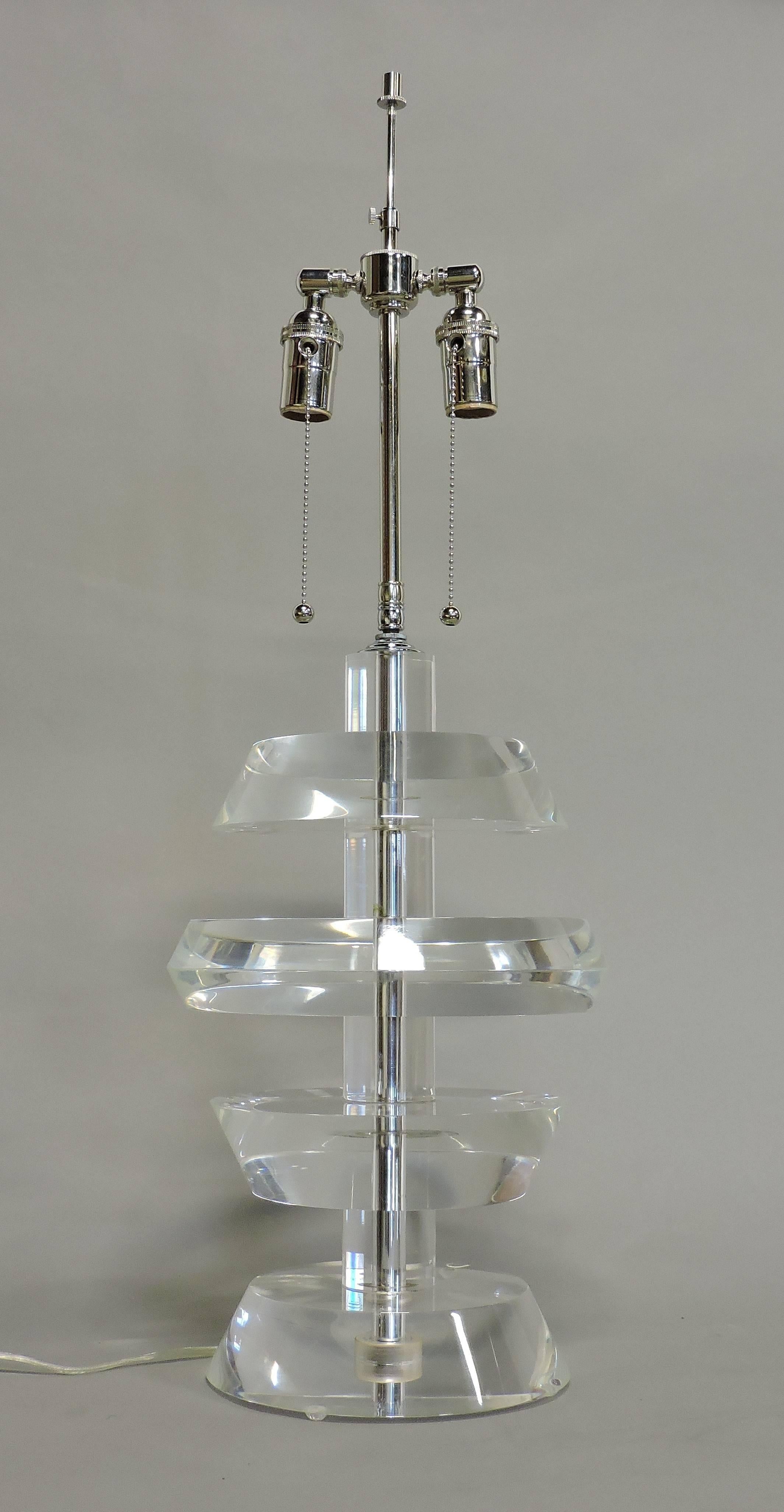 Beautiful and heavy high quality Lucite lamp in the style of Karl Springer. This lamp has thick circular discs of stacked clear Lucite, a double light socket, and all new wiring. The shade is not included.