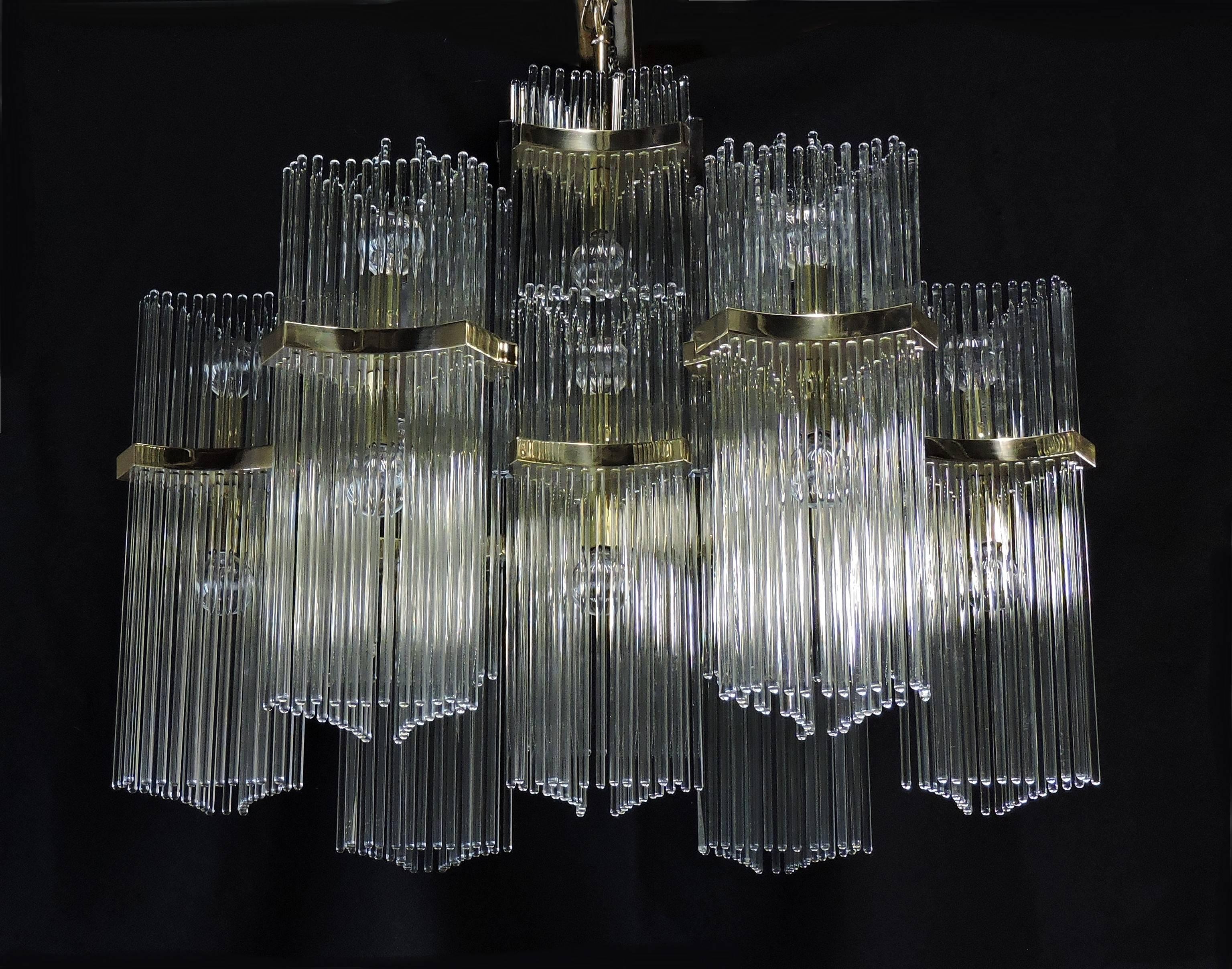 Large and elegant Mid-Century Modern chandelier designed by Gaetano Sciolari for high quality lighting manufacturer, Lightolier. This chandelier has ten triangular brass arms that hold hundreds of long and thin glass rods. It takes 21 candelabra